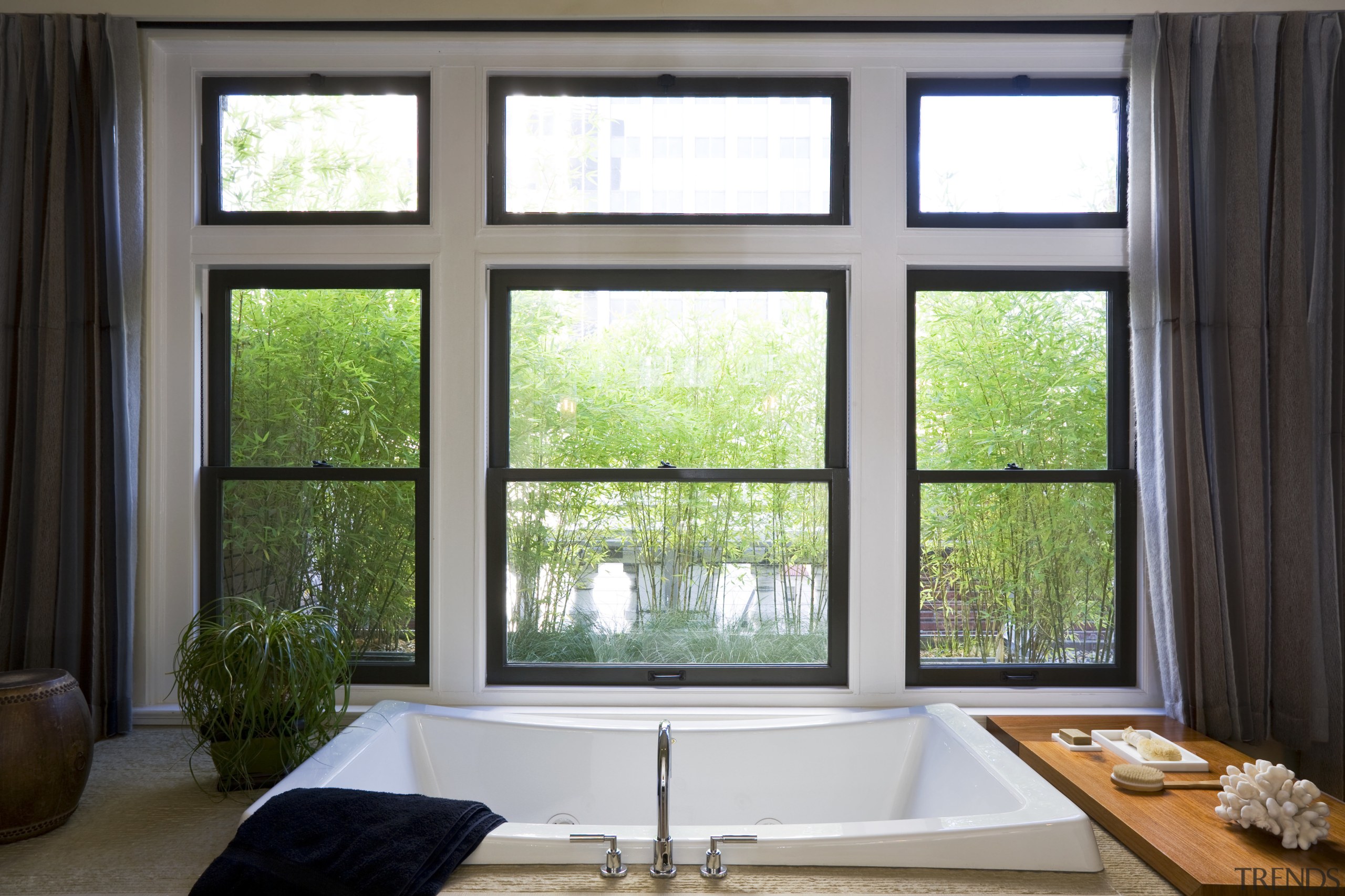 View of bathtub which is set into a daylighting, home, interior design, real estate, sash window, window, window covering, window treatment, wood, black