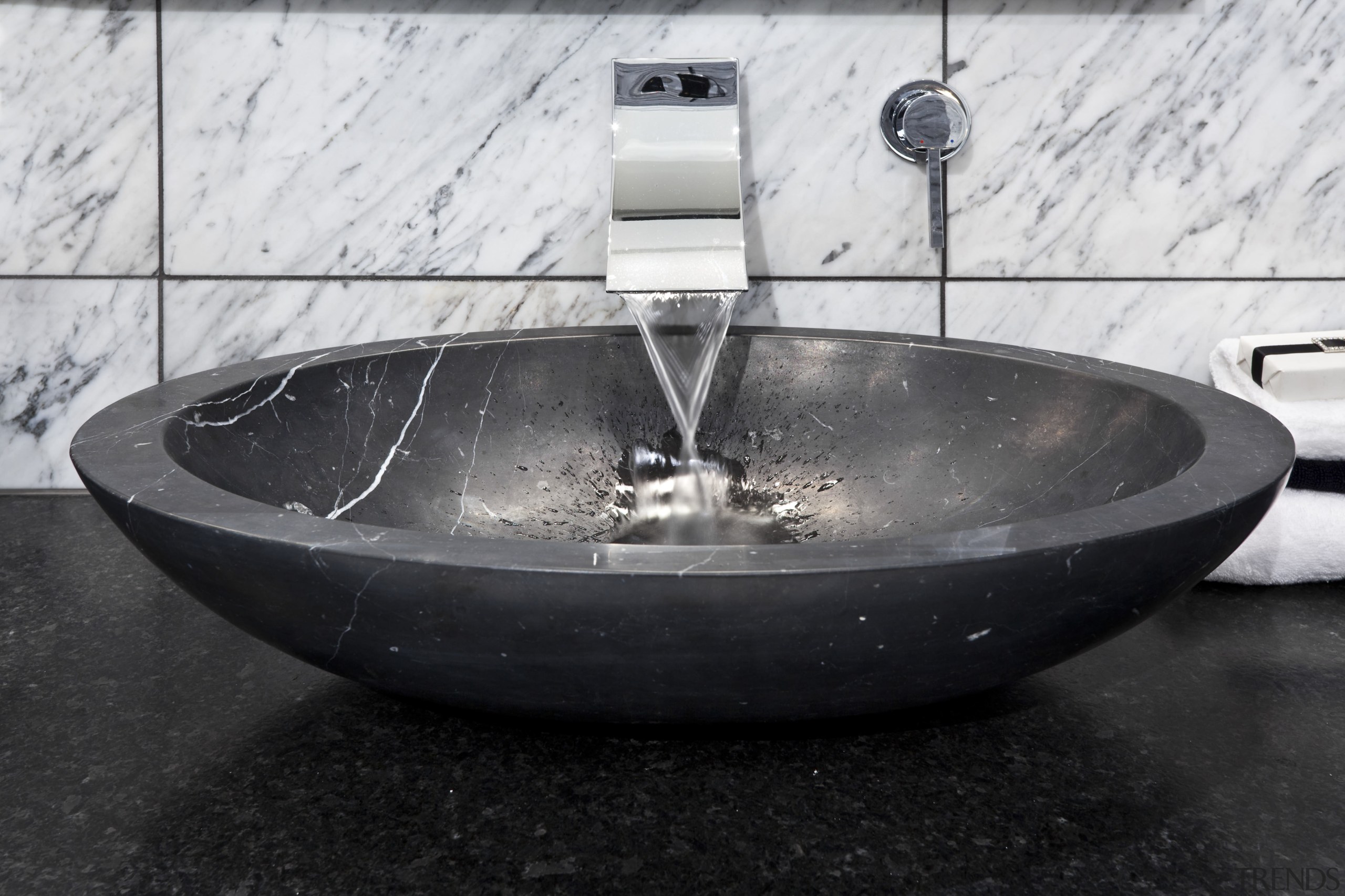 View of bedroom and bathroom with grey, black plumbing fixture, sink, water, black, white