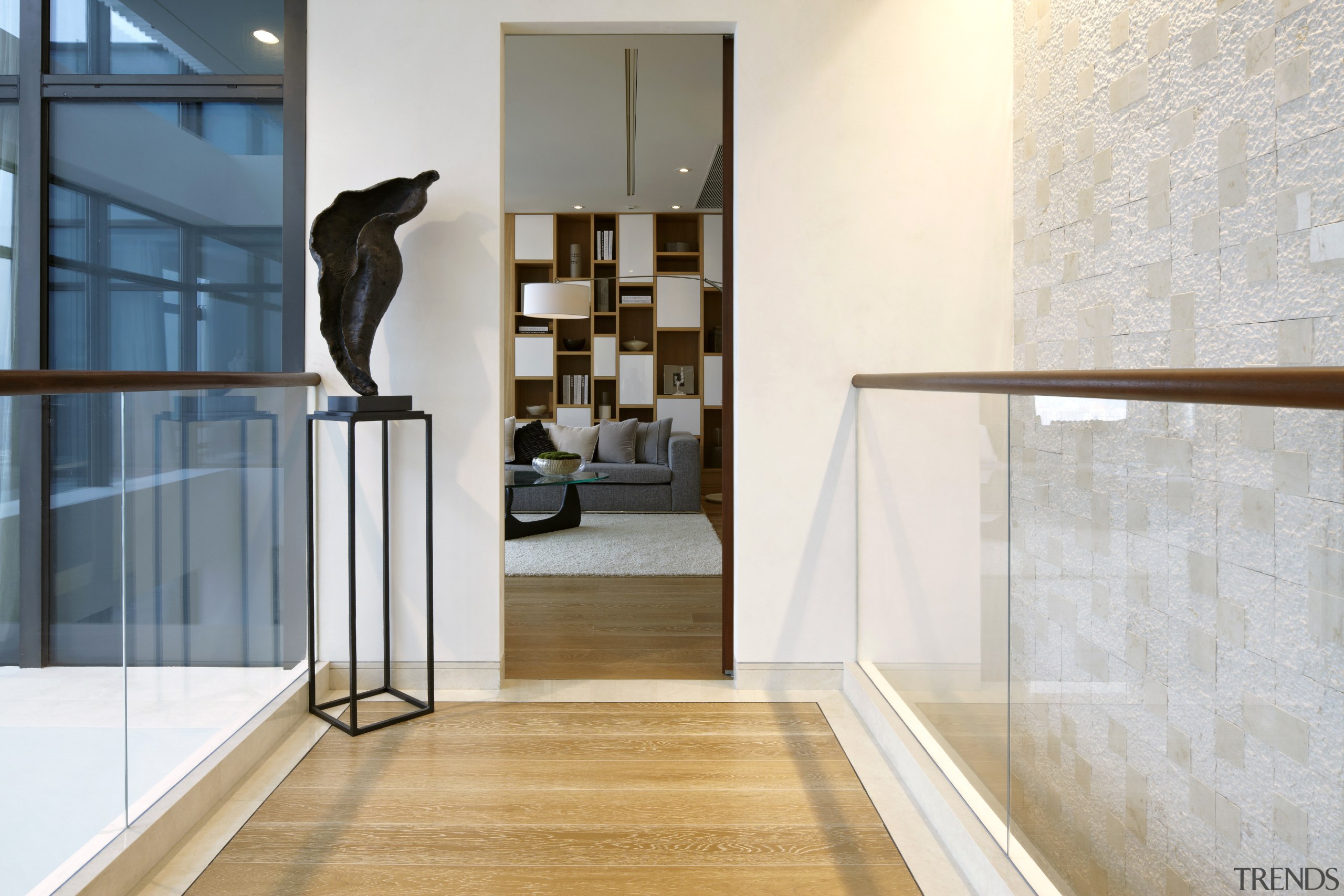 The shelving units featured in this family room floor, flooring, glass, handrail, hardwood, home, interior design, laminate flooring, wall, window, wood, wood flooring, white