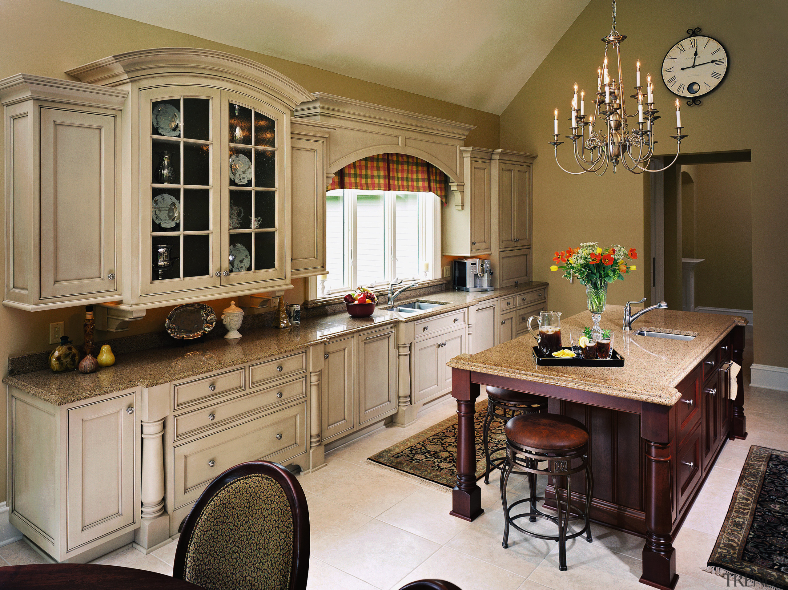 view of this kitchen featuring handcafted cream kitchen cabinetry, countertop, cuisine classique, furniture, interior design, kitchen, room, brown