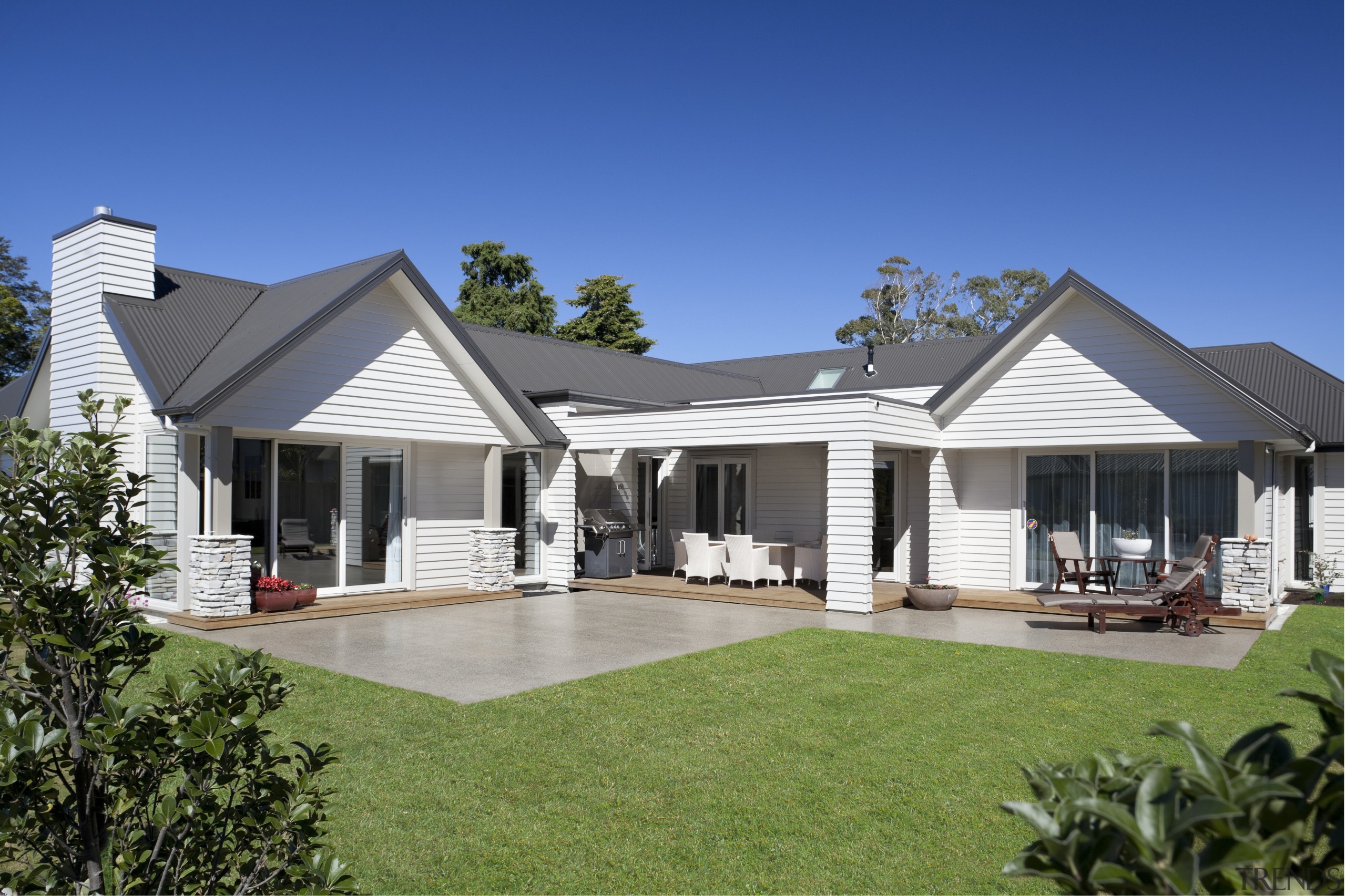 Exterior of house with white cladding, grey roof backyard, cottage, elevation, estate, facade, farmhouse, home, house, outdoor structure, property, real estate, residential area, roof, siding, villa, window, yard, blue