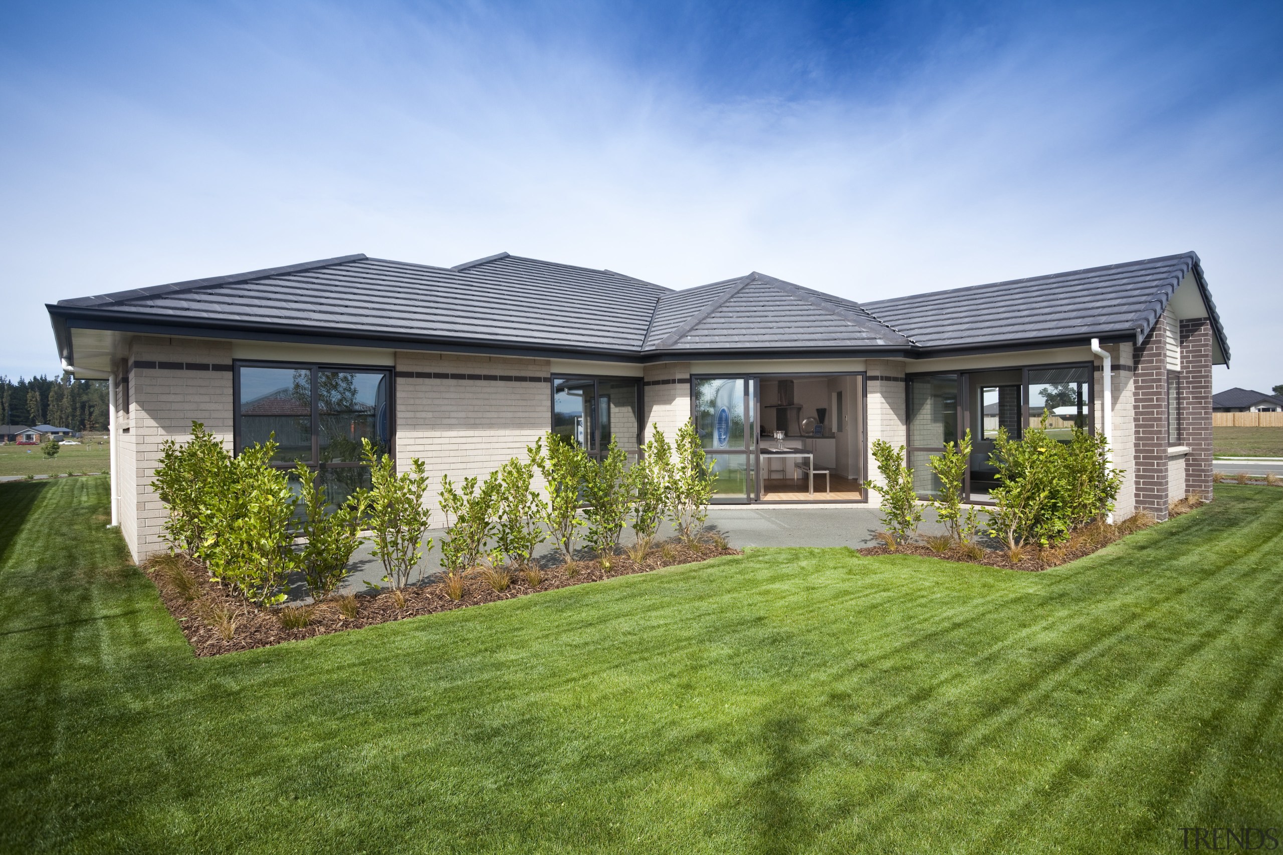 View of Platinum Homes show home with solid backyard, cottage, elevation, estate, facade, farmhouse, grass, home, house, land lot, landscape, lawn, property, real estate, residential area, roof, siding, sky, villa, yard, green
