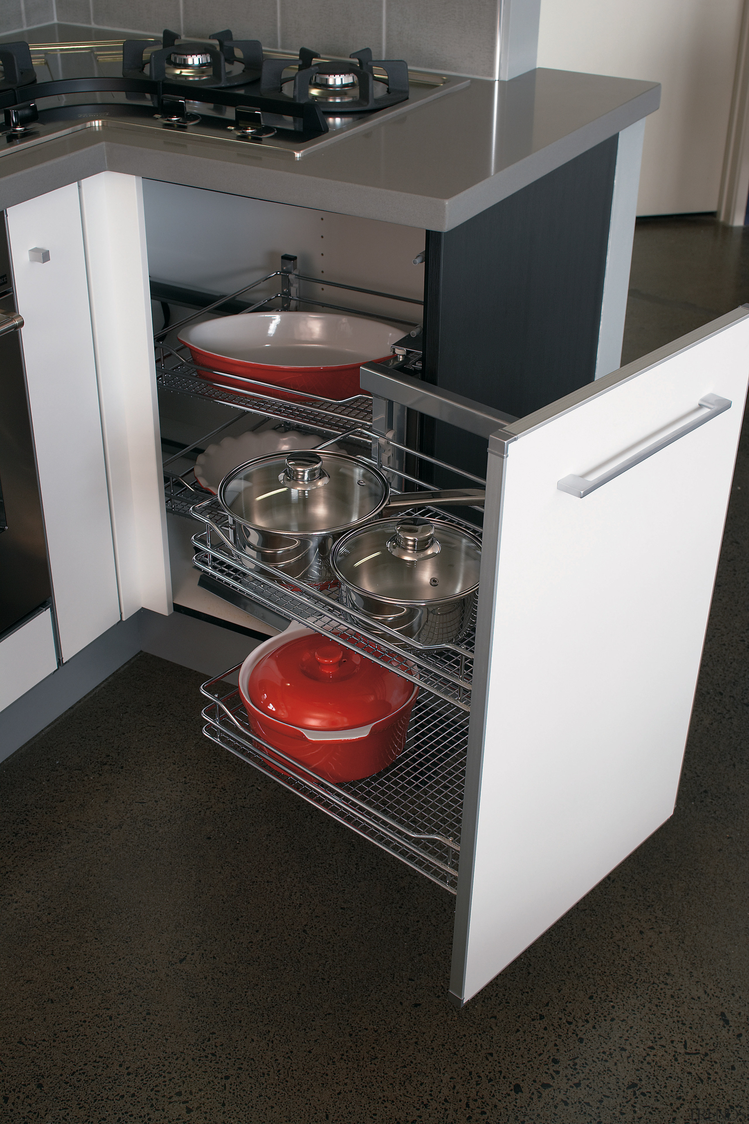 view of the kitchen cabinetry featuring pull out furniture, home appliance, kitchen, kitchen appliance, kitchen stove, major appliance, black