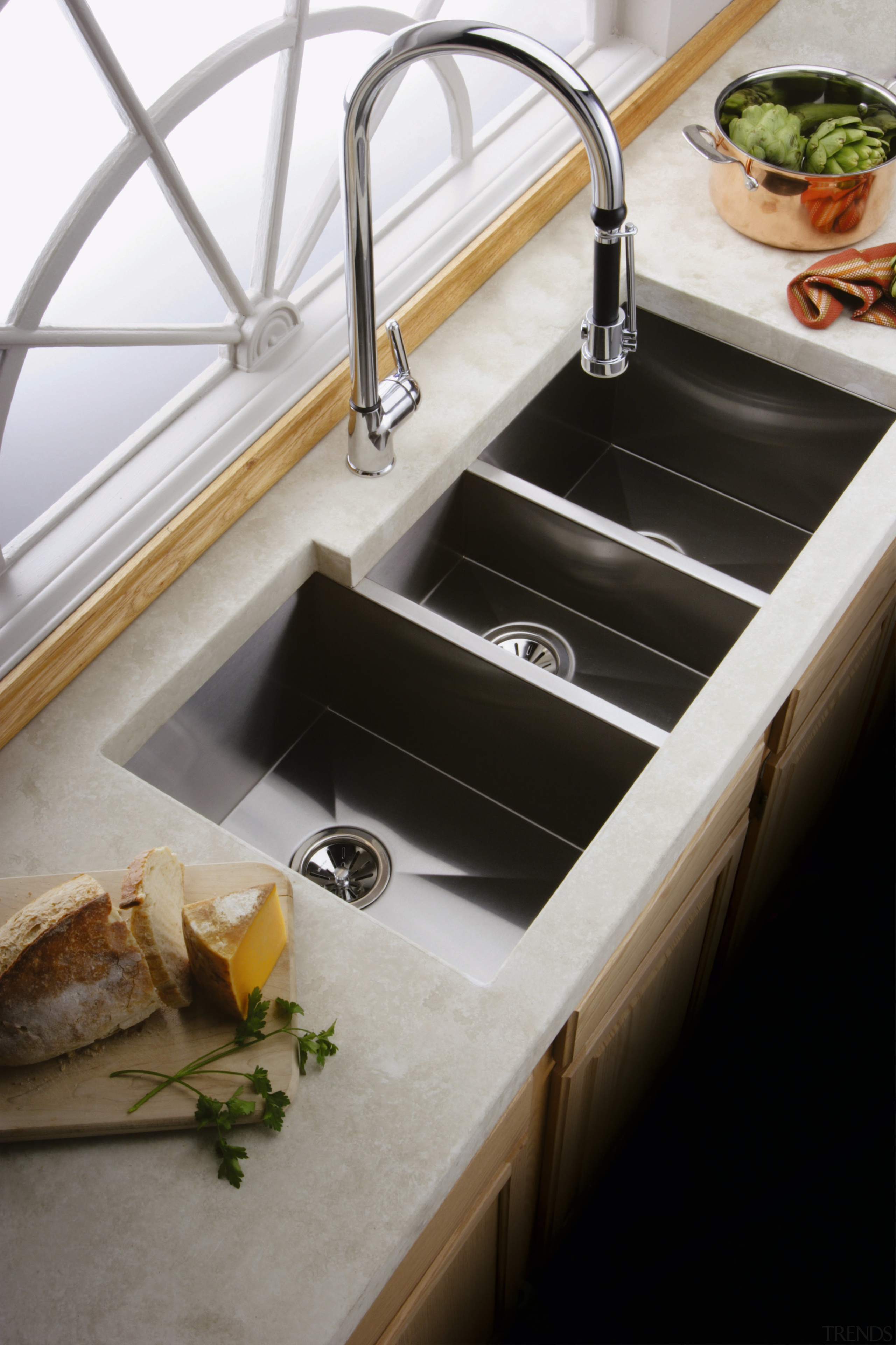 A viewof a kitchen, white benchtop, long square countertop, plumbing fixture, sink, tap, gray, black