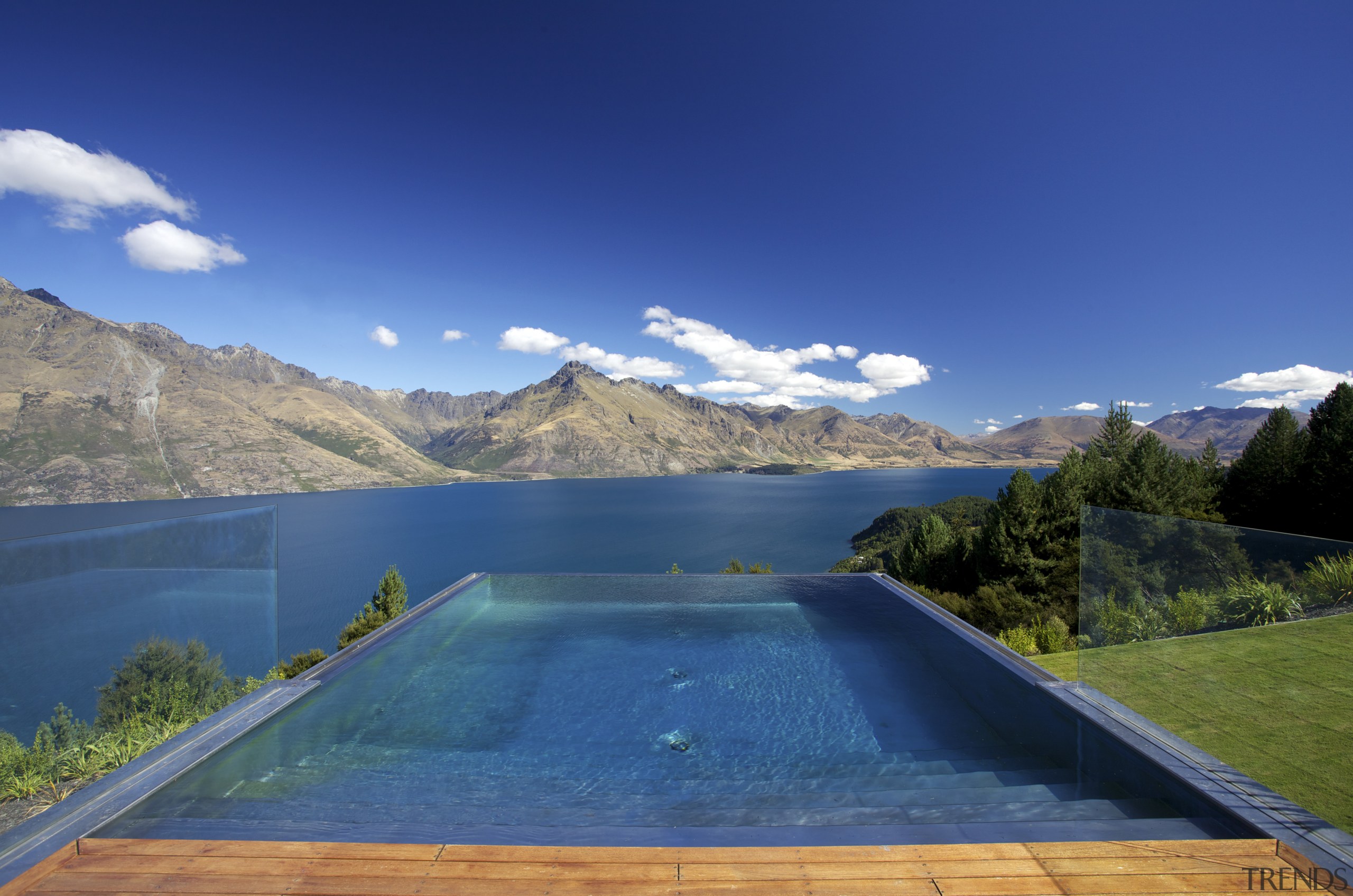 This hilltop house, in Queenstown, features an infinity alps, cloud, estate, lake, landscape, mount scenery, mountain, mountain range, nature, reflection, reservoir, sky, swimming pool, water, water resources, blue