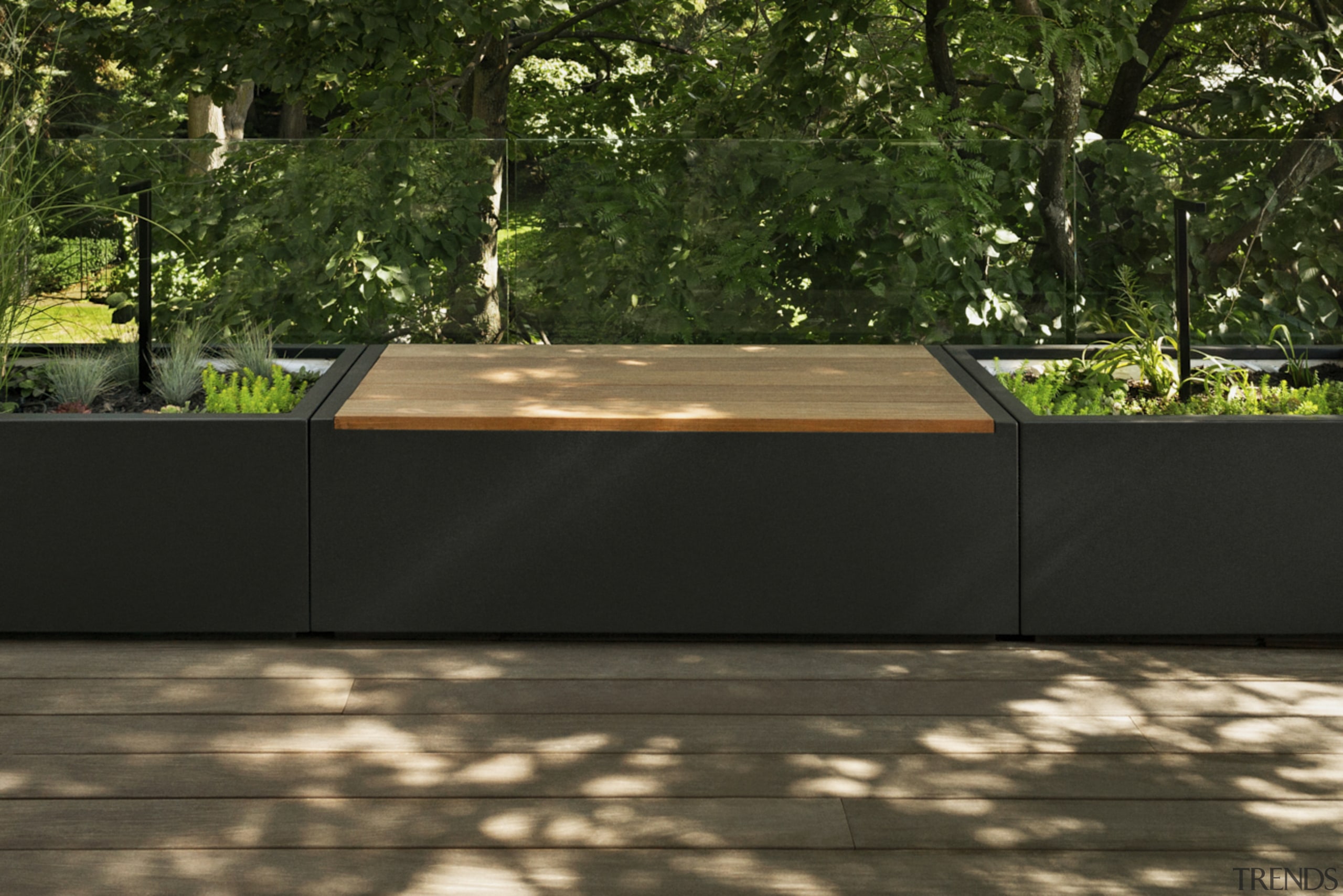 The custom made planters incorporate seating and hide 