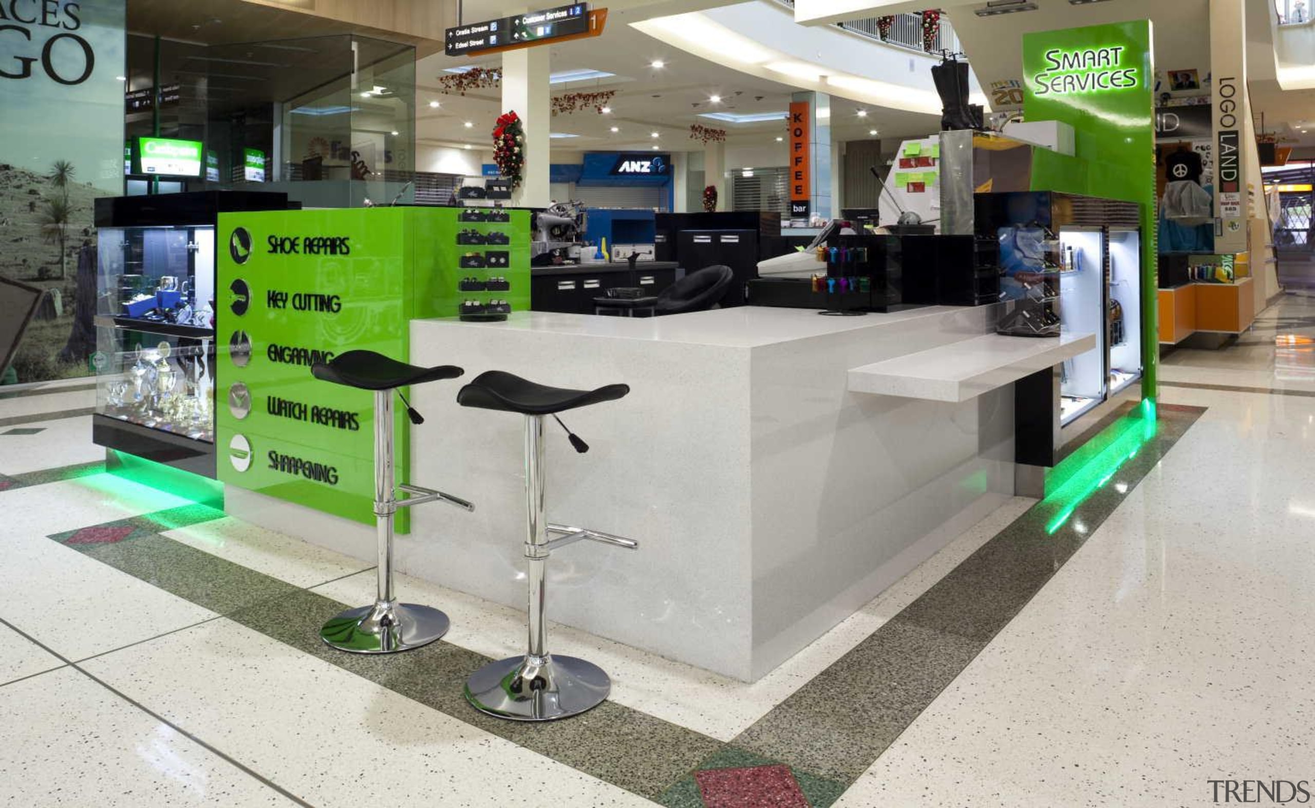 Kiosk designed with matching green neon light - product, retail, gray