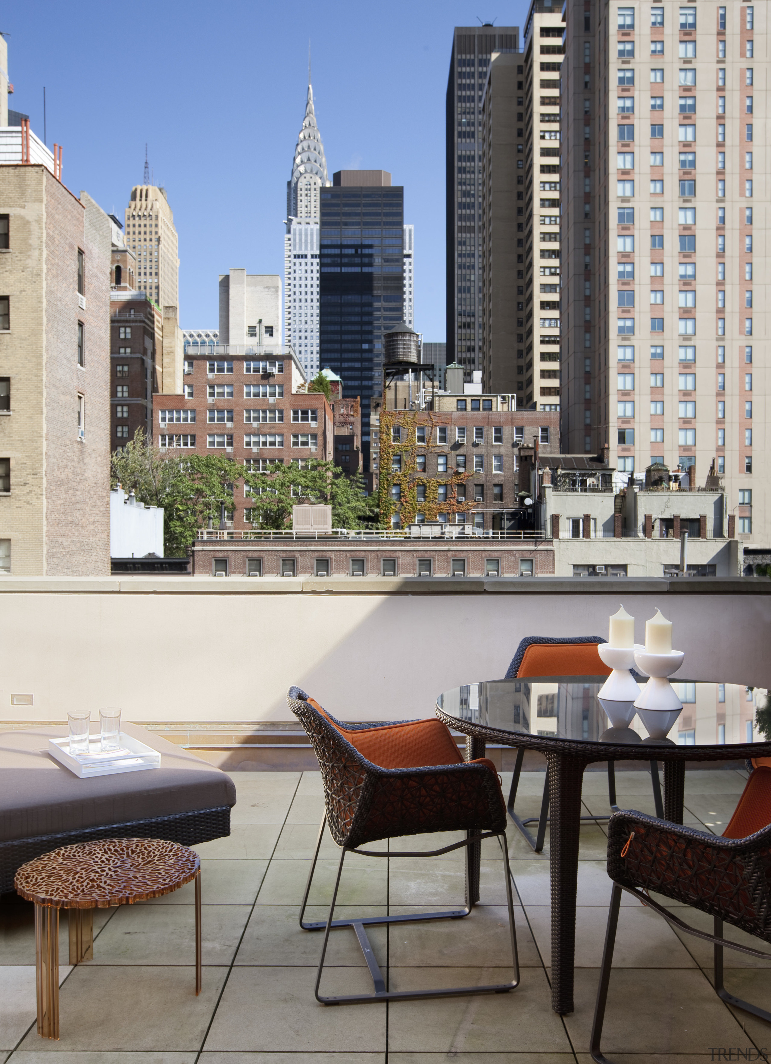 Rooftop dining area with orange seats and round apartment, architecture, balcony, building, city, condominium, downtown, furniture, home, outdoor structure, real estate, residential area, roof, skyline, skyscraper, table, tower block, urban area, window, white