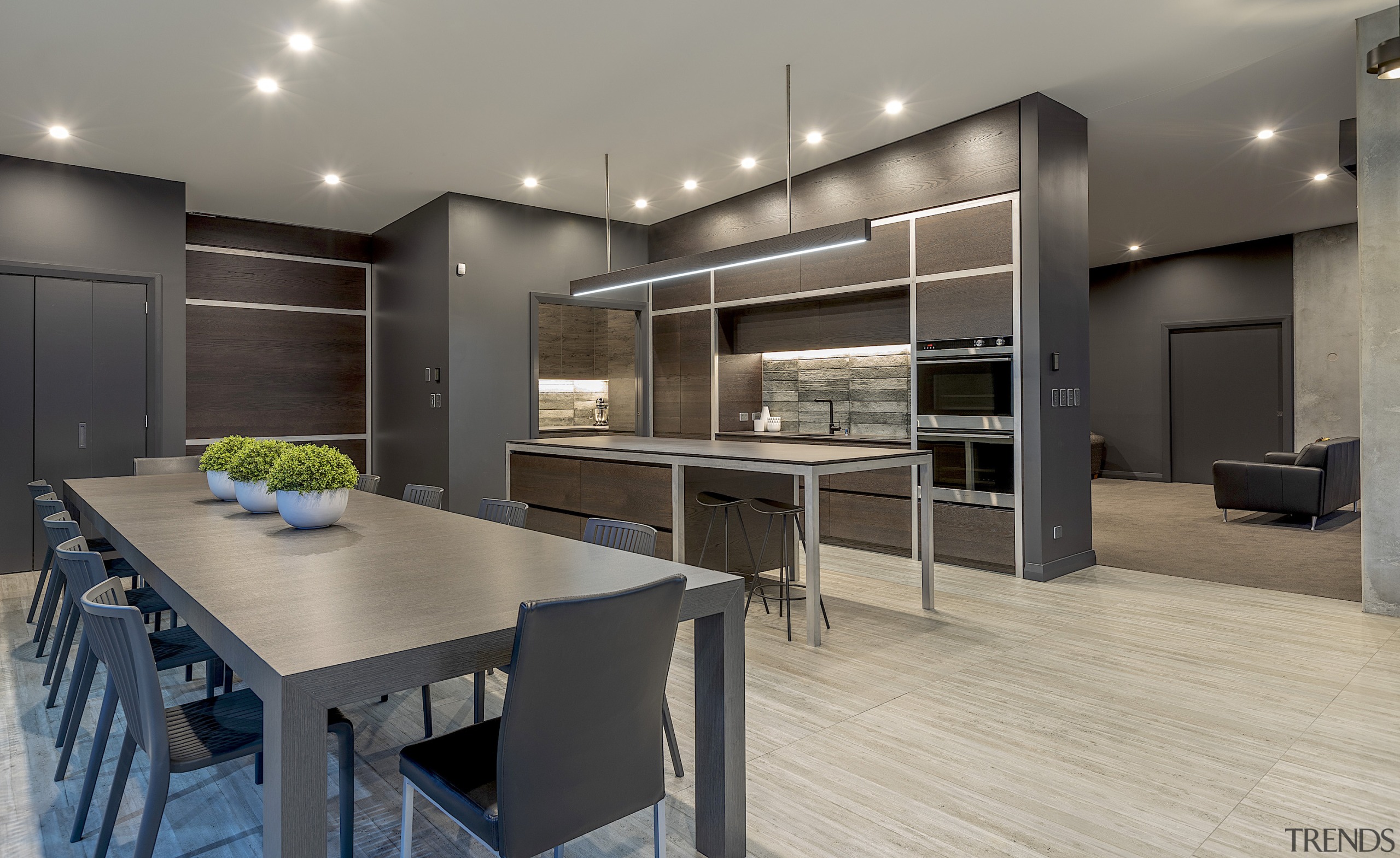 The kitchen cabinetry continues the aesthetic of the gray, black