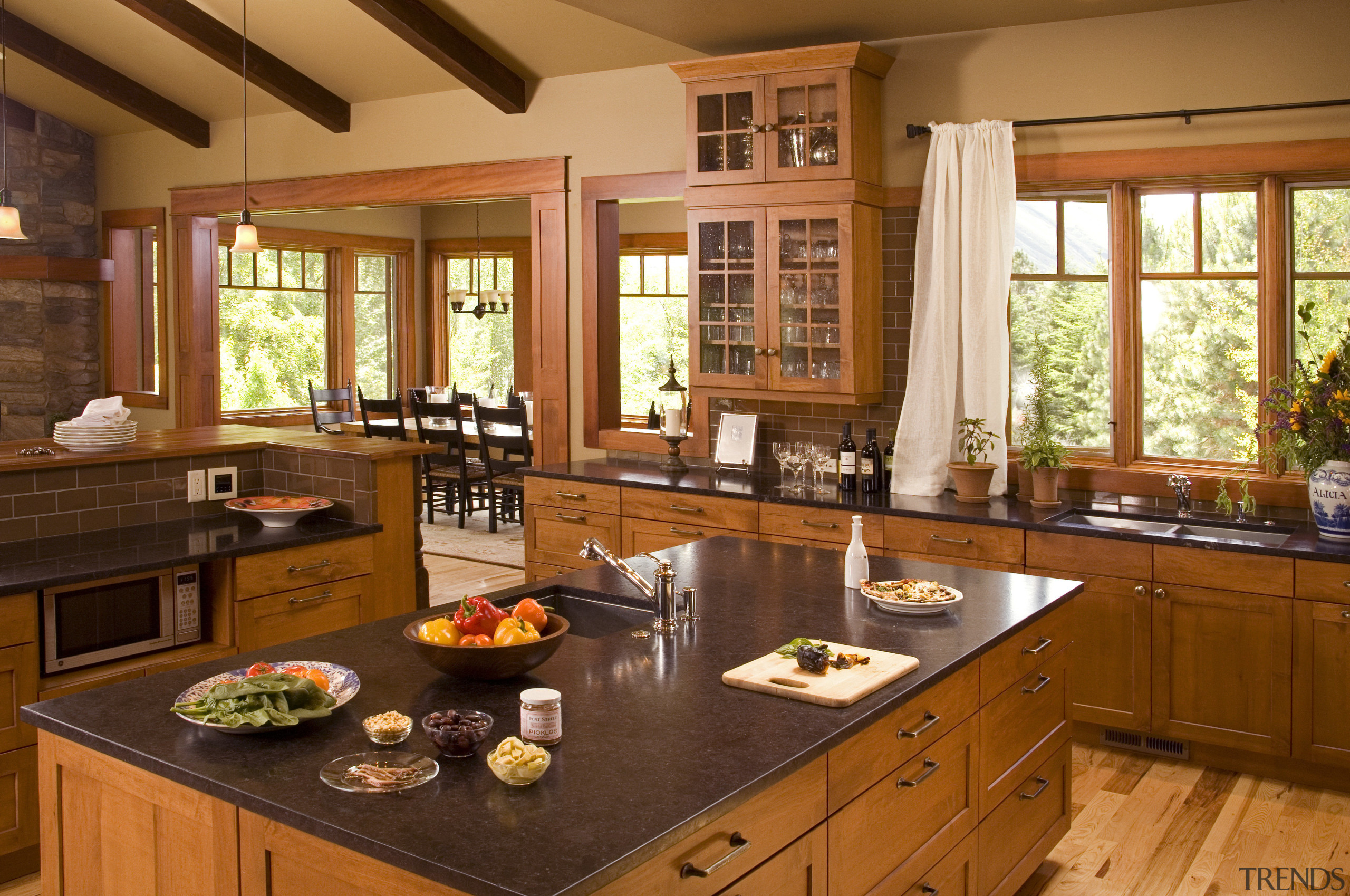 View of a Northwestern-styled kitchen with extensive wood cabinetry, countertop, cuisine classique, interior design, kitchen, real estate, room, window, brown