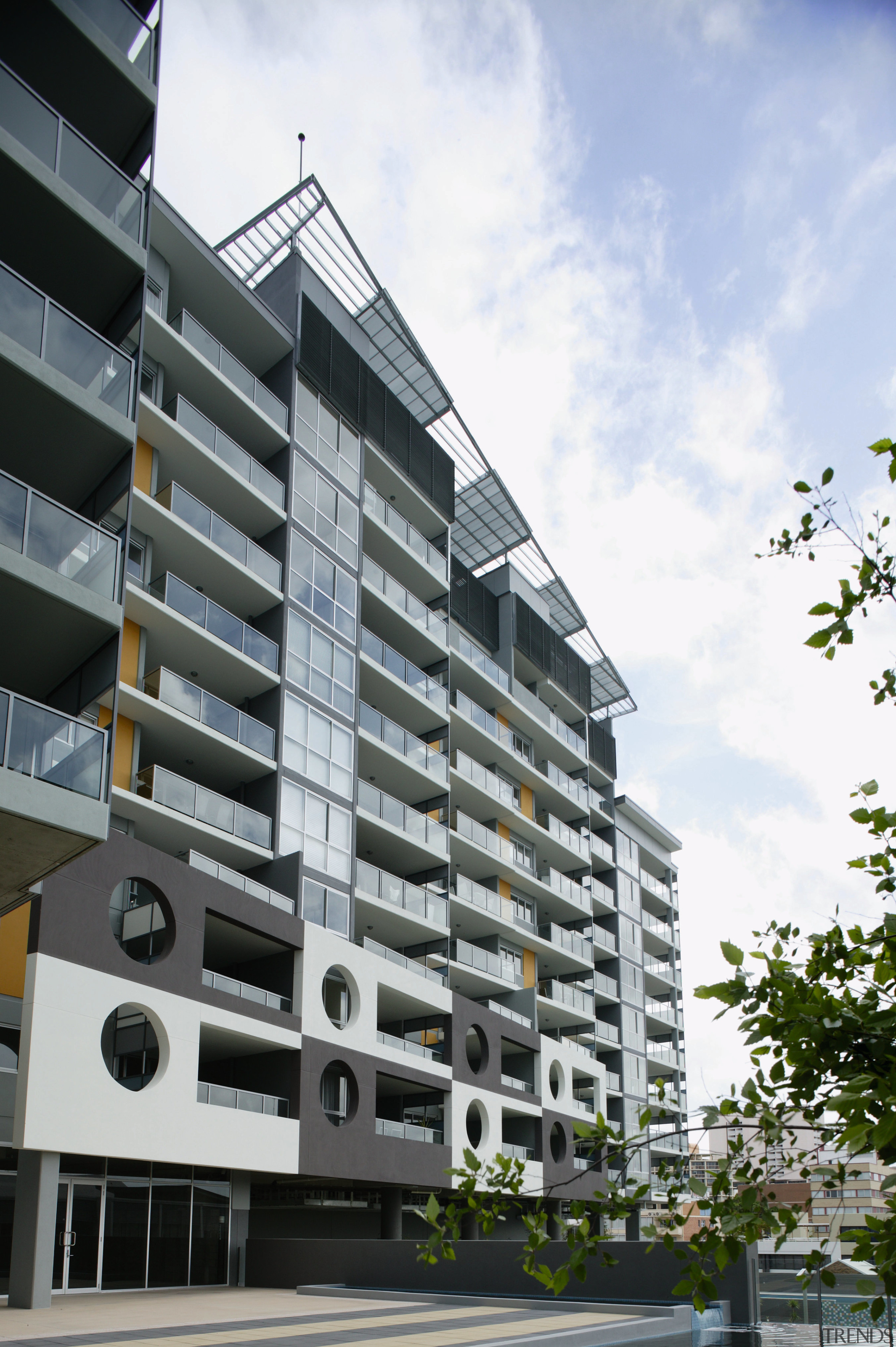 An exterior view of some apartments. - An apartment, architecture, building, commercial building, condominium, corporate headquarters, daytime, elevation, facade, home, house, metropolitan area, mixed use, neighbourhood, property, real estate, residential area, sky, tower block, urban design, white, gray