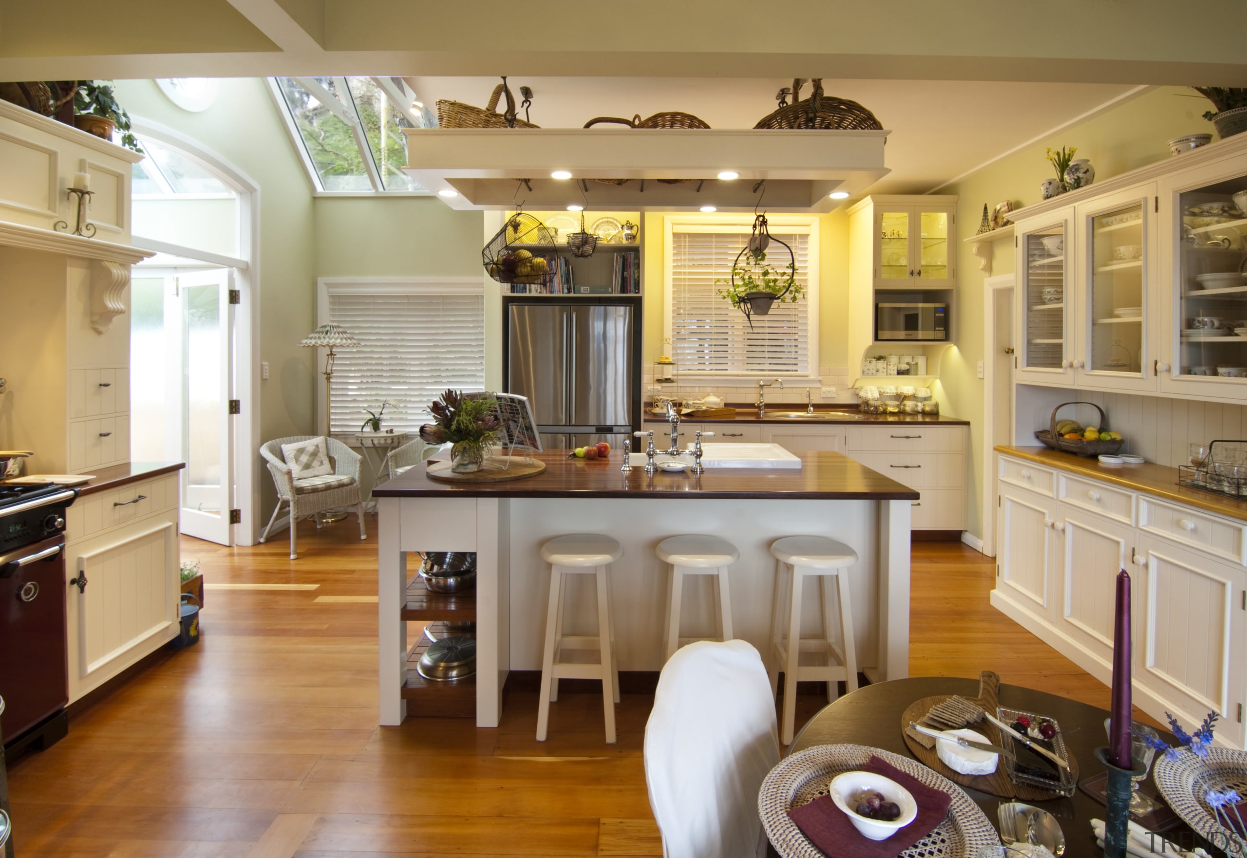 central island features seating and white stoold. rangehood cabinetry, ceiling, countertop, cuisine classique, hardwood, home, interior design, kitchen, living room, room, brown, orange