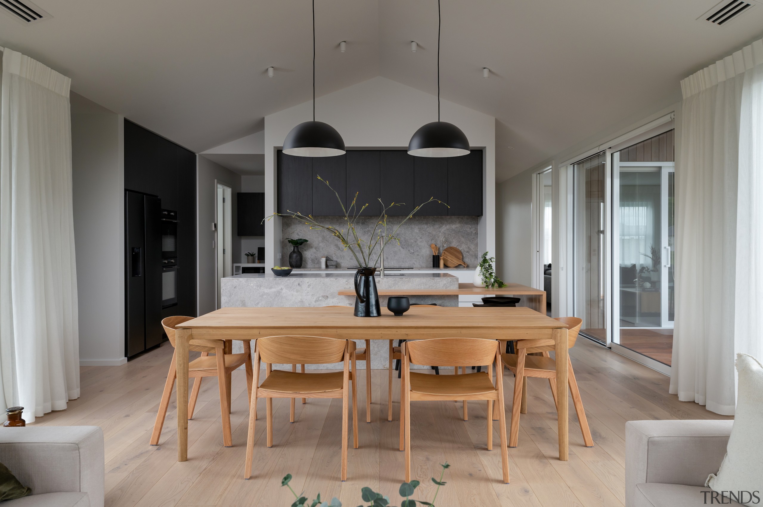 The kitchen seen from the adjacent living spaces. 