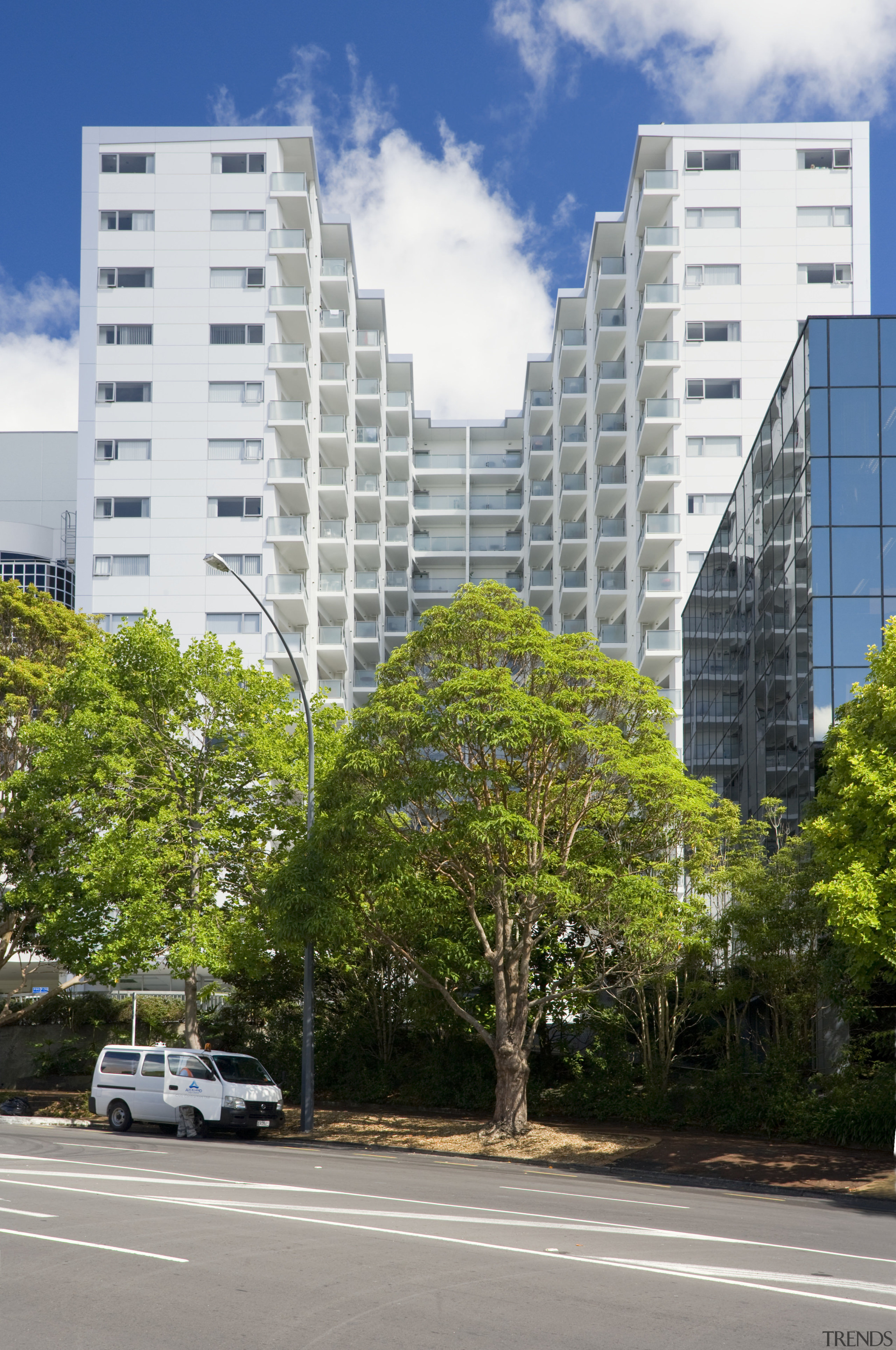 Exterior view of the Federal Apartments which where apartment, architecture, arecales, building, city, condominium, daytime, downtown, metropolis, metropolitan area, mixed use, neighbourhood, palm tree, plant, real estate, residential area, road, sky, skyscraper, suburb, tower block, tree, urban area, urban design, white