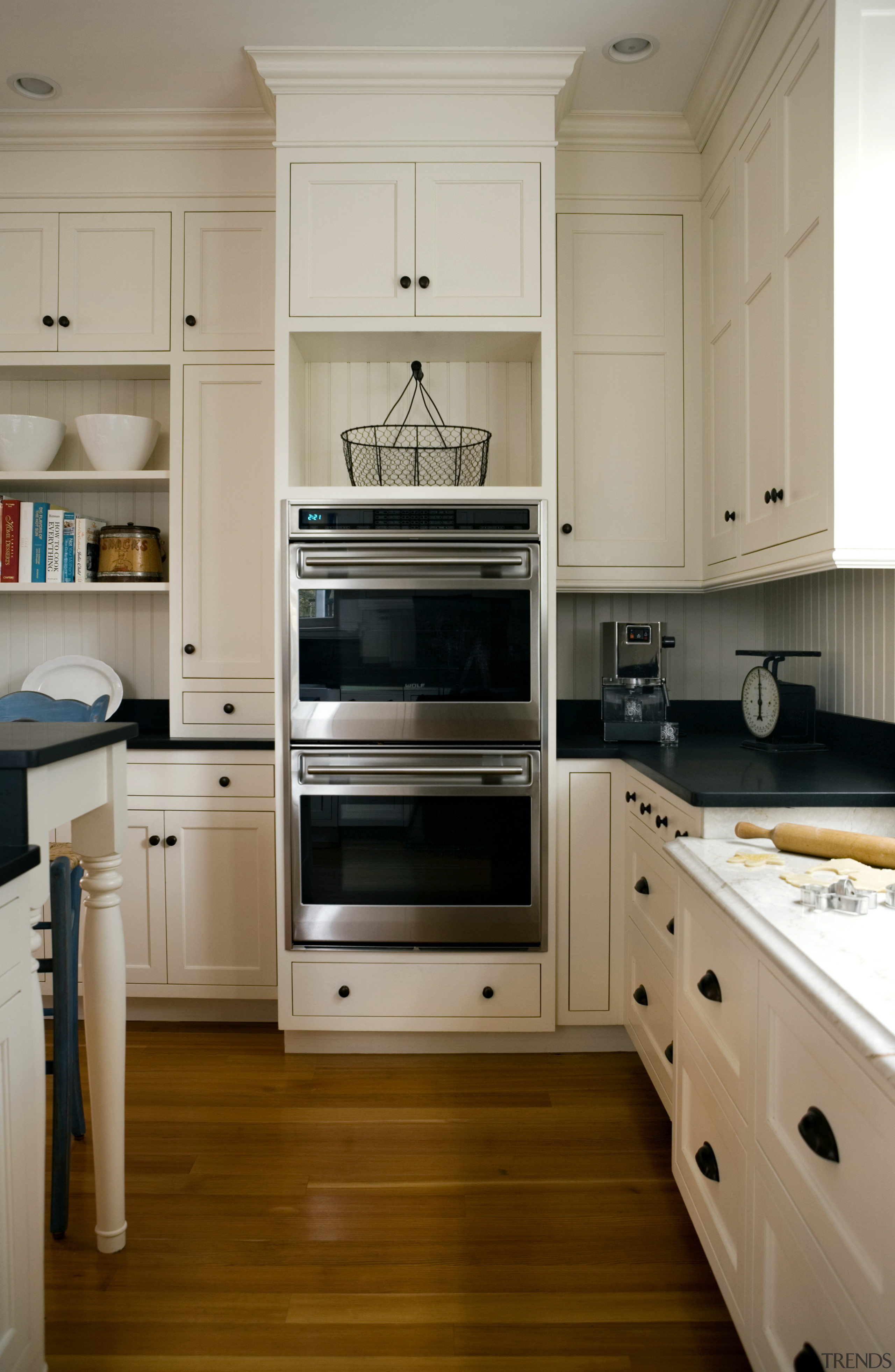 View of kitchen with light-toned cabinets and dark-toned cabinetry, countertop, cuisine classique, floor, flooring, hardwood, home appliance, kitchen, kitchen appliance, kitchen stove, major appliance, room, gray, brown