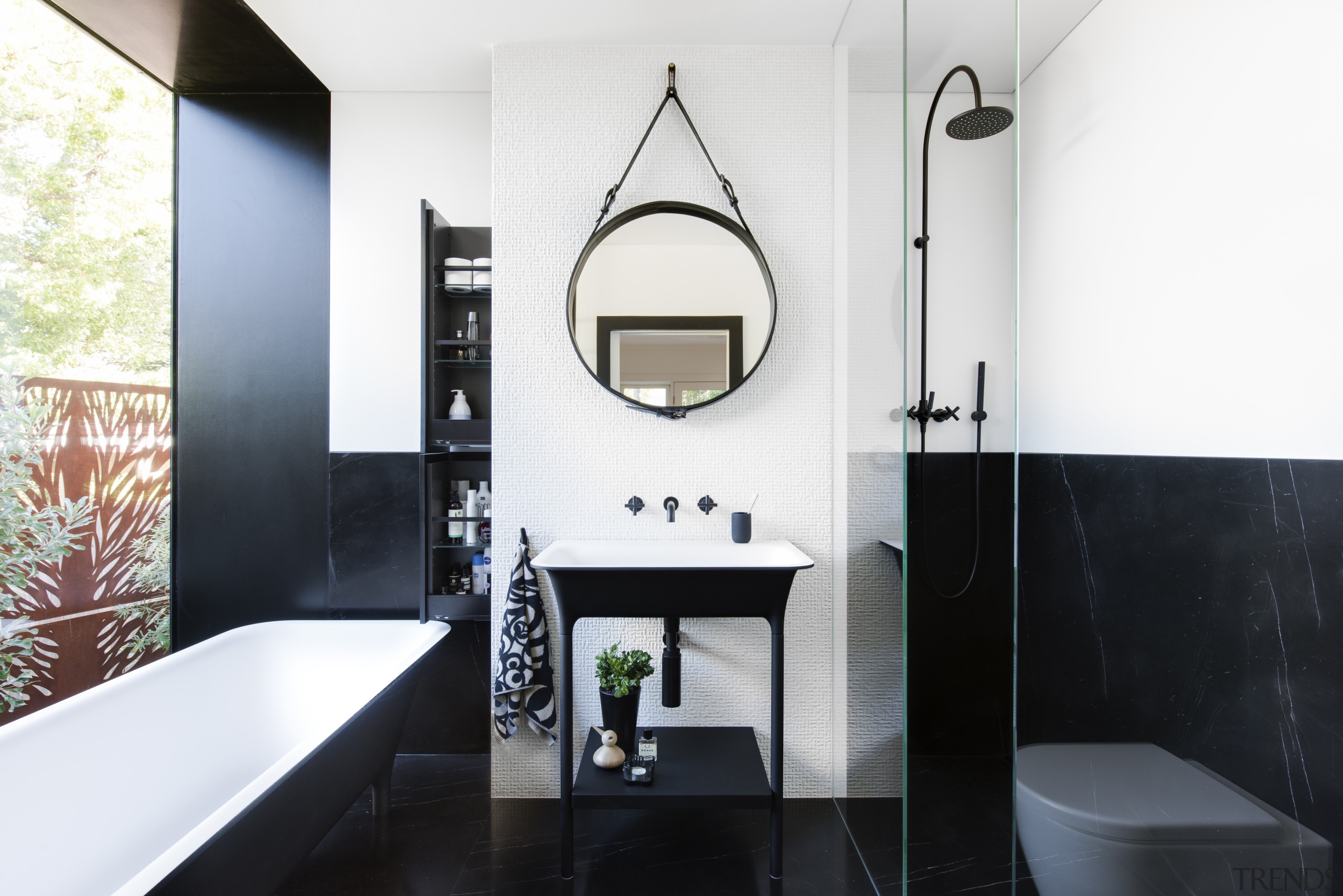 This contemporary bathroom, located in a modest space, architecture, bathroom, black, black-and-white, floor, plumbing fixture, sink, tap, tile, white, black, freestanding tub, round mirror, Minosa, Darren Genner