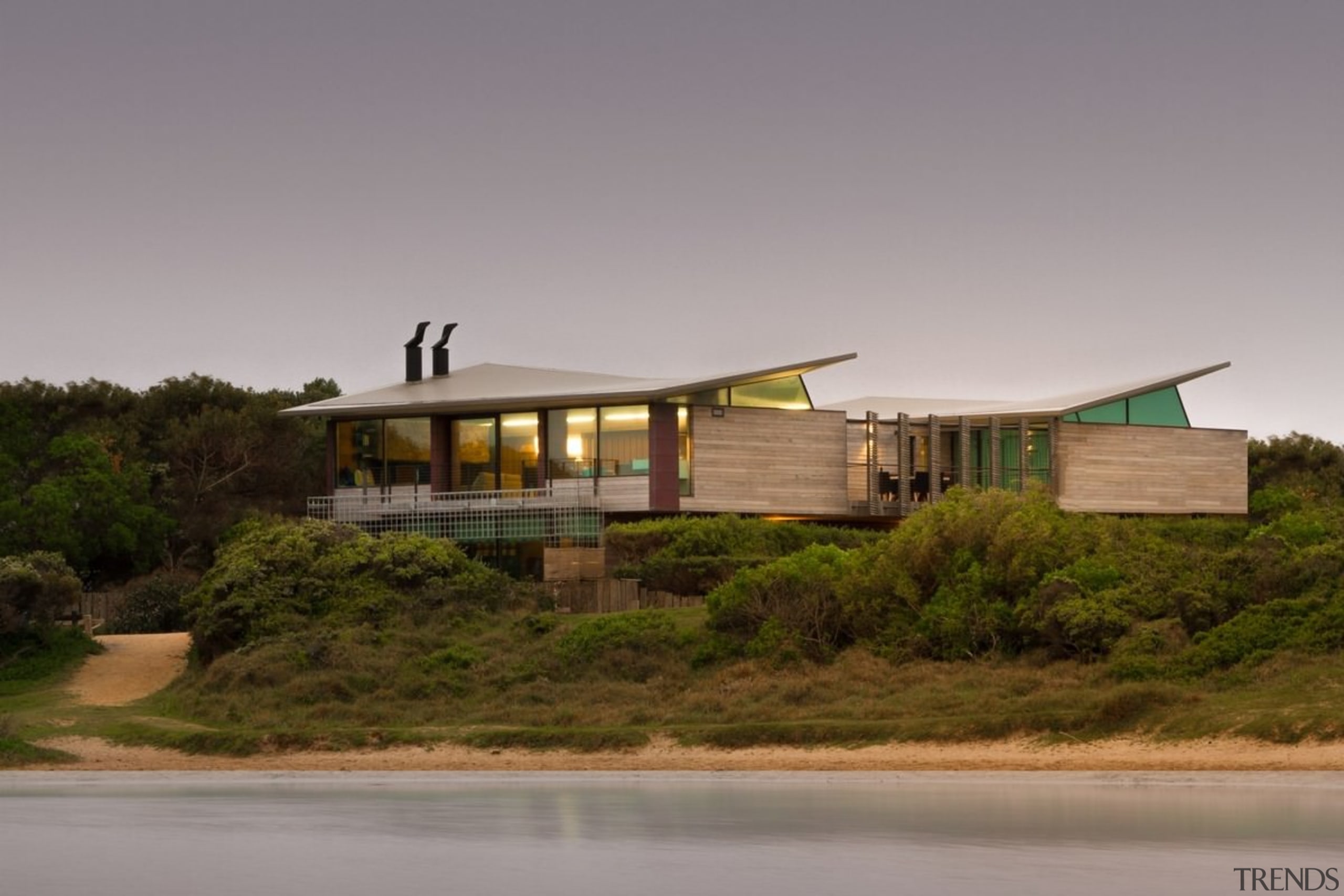 From the water, the home appears to rise architecture, cottage, home, house, landscape, property, real estate, roof, sky, gray, brown