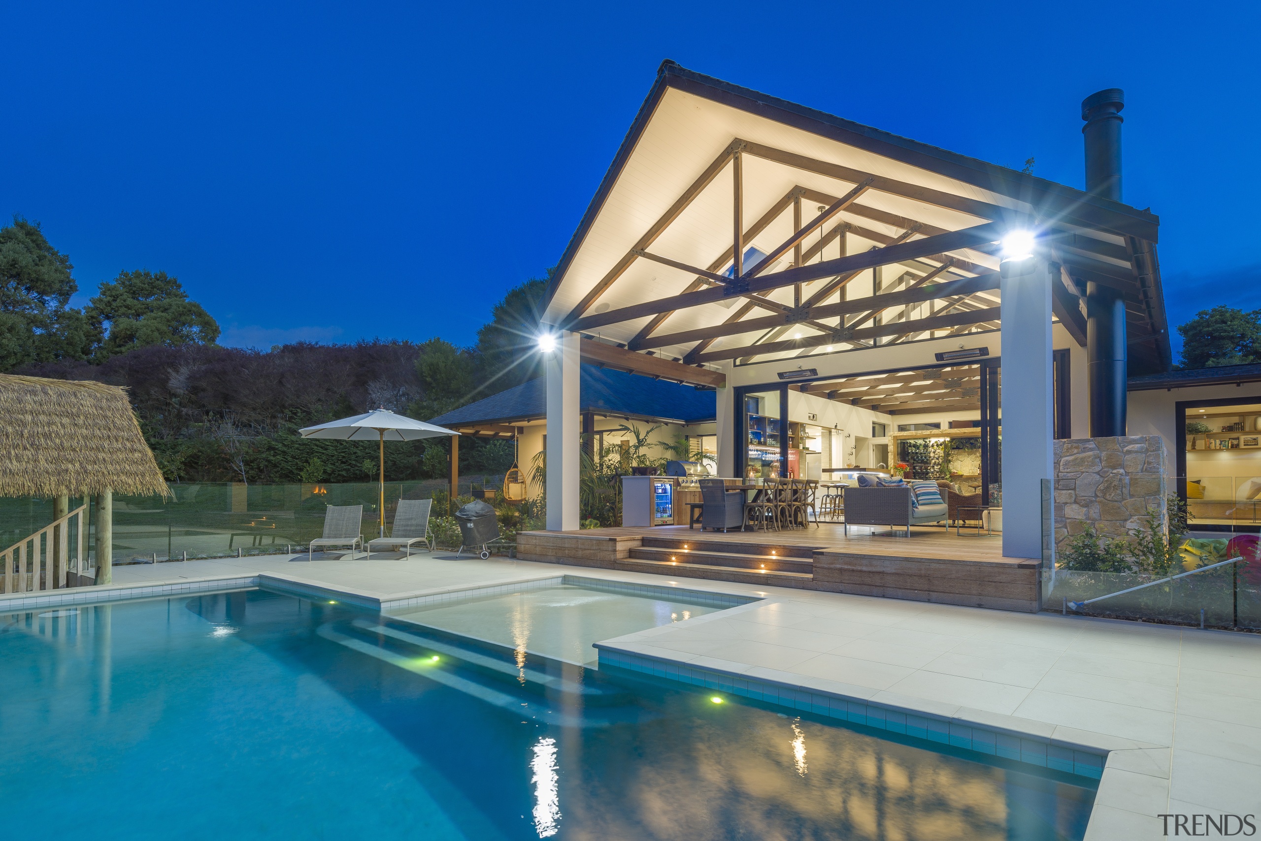 This tropical style home is all about entertaining. architecture, backyard, building, design, eco hotel, estate, home, house, interior design, leisure, leisure centre, lighting, mansion, patio, porch, property, real estate, residential area, resort, roof, shade, swimming pool, villa, blue