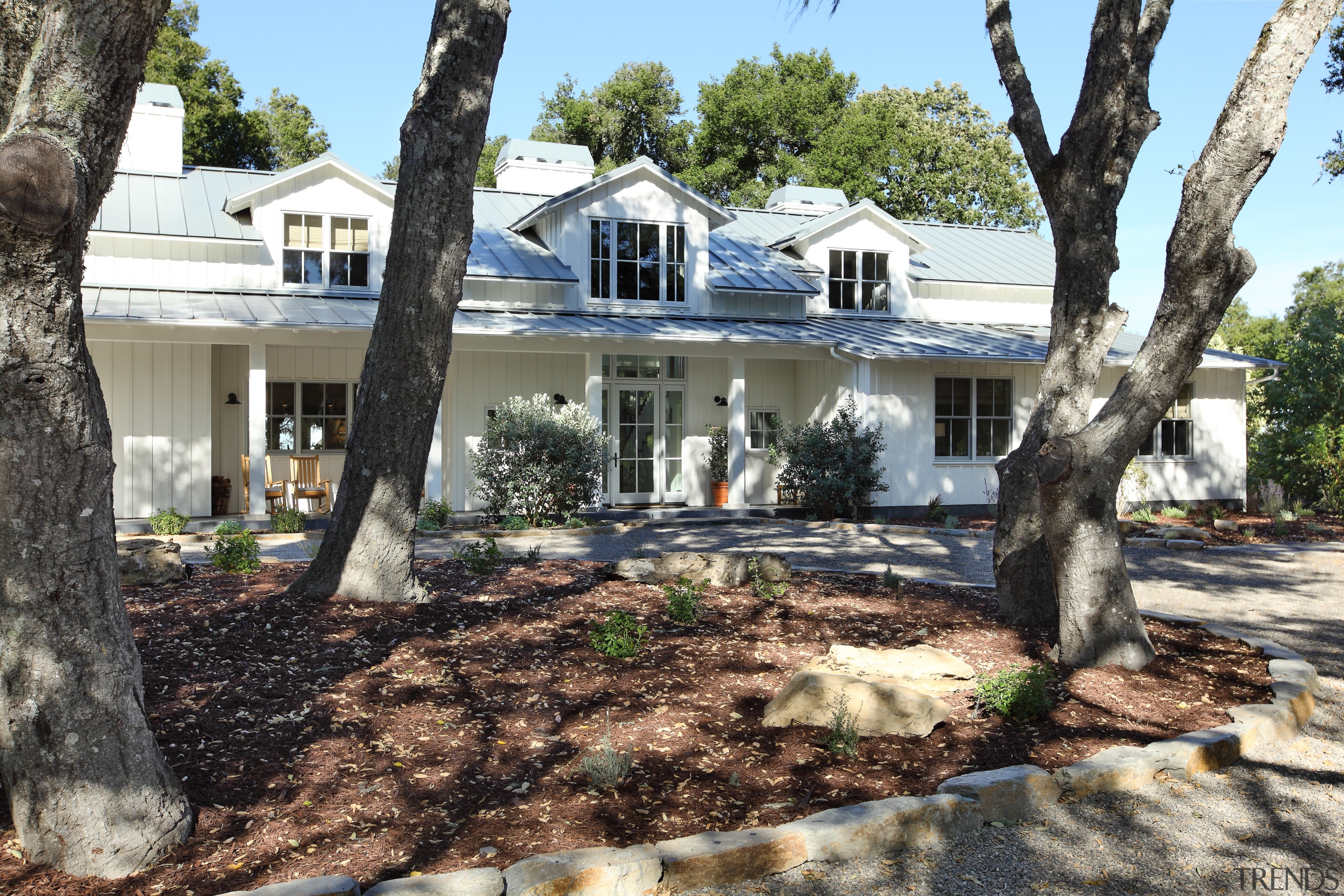 View of exterior with trees in foreground. - cottage, estate, home, house, outdoor structure, plant, property, real estate, residential area, tree, yard, black