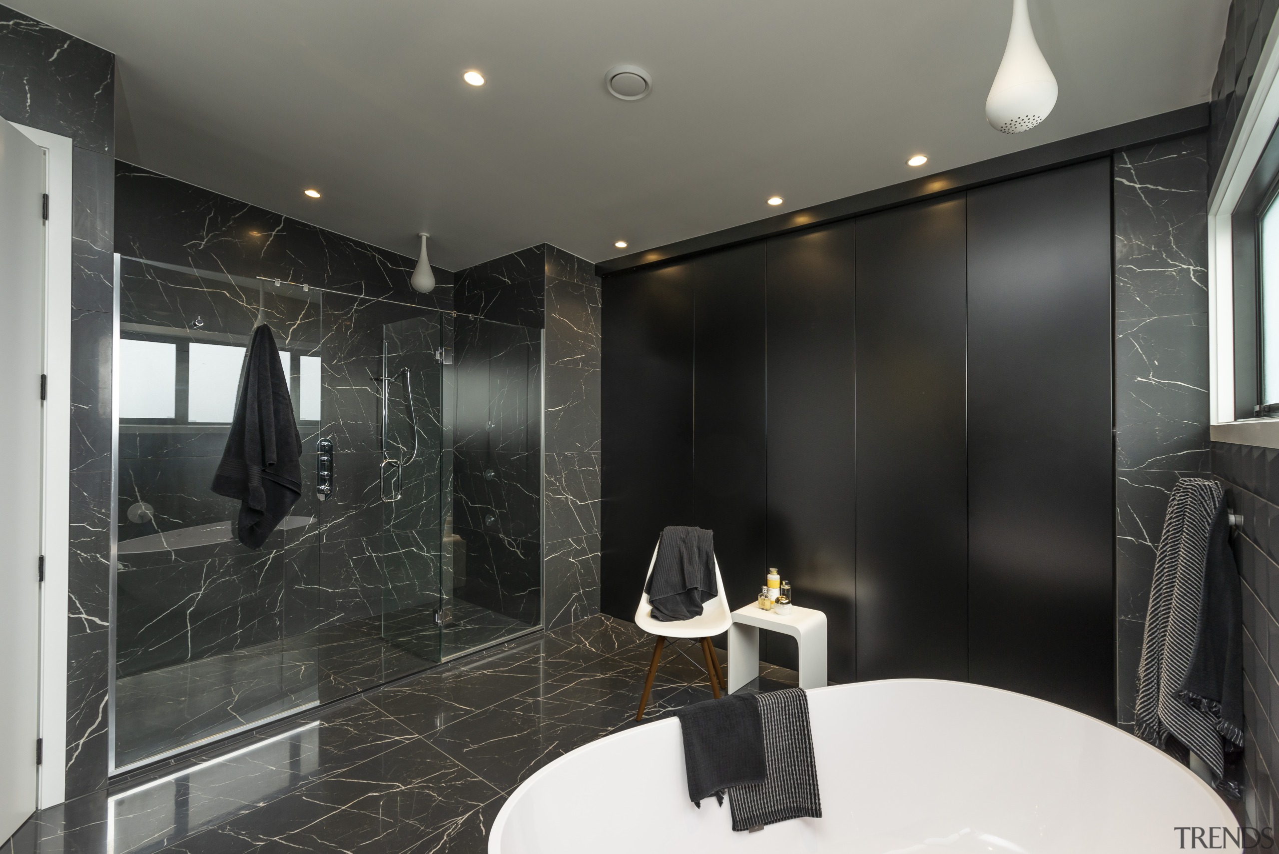 This shower is spacious enough for two, while bathroom, flooring, interior design, room, black, gray