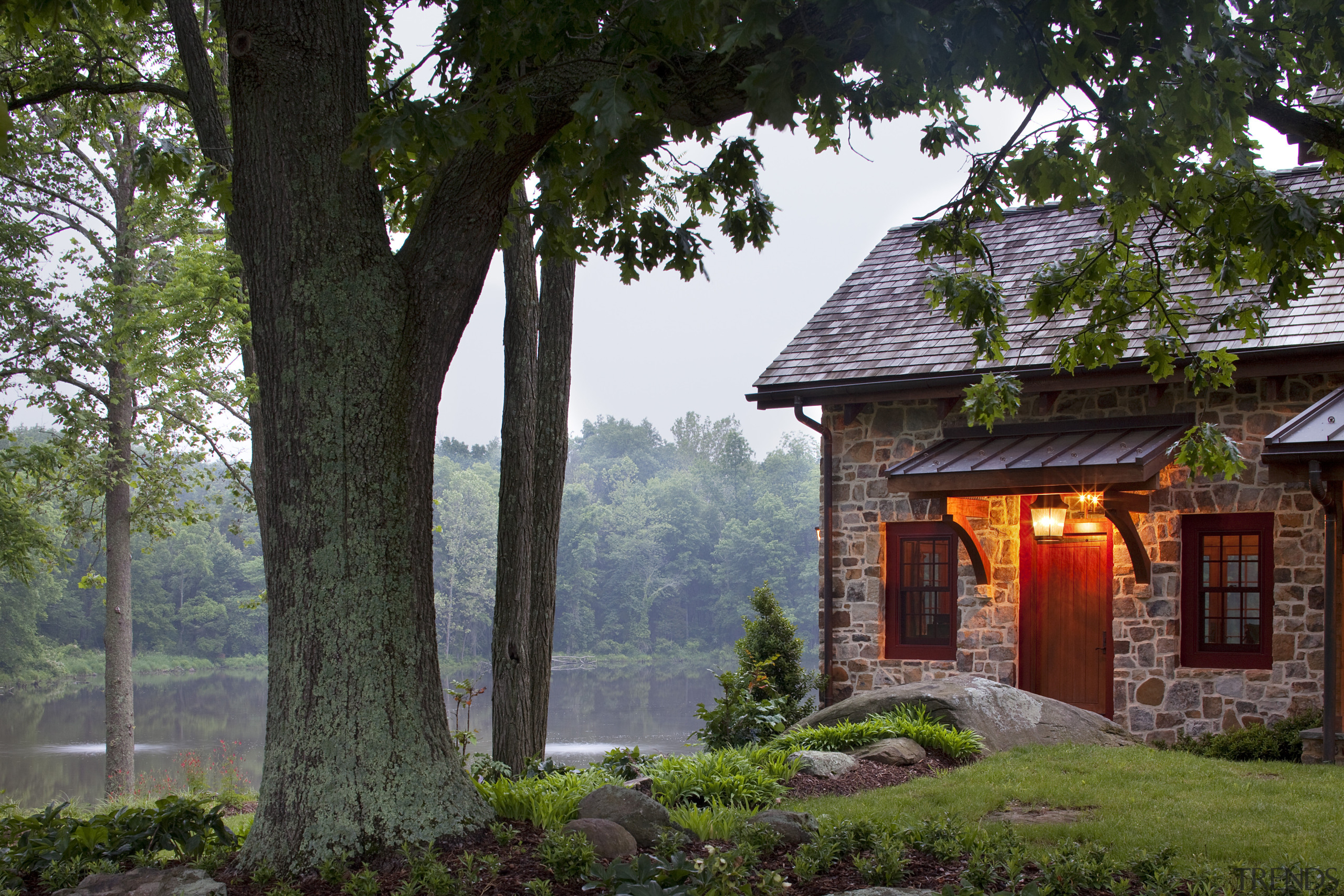 View of stone buildling with tree in foreground. cottage, estate, home, house, landscape, nature, plant, real estate, tree, black