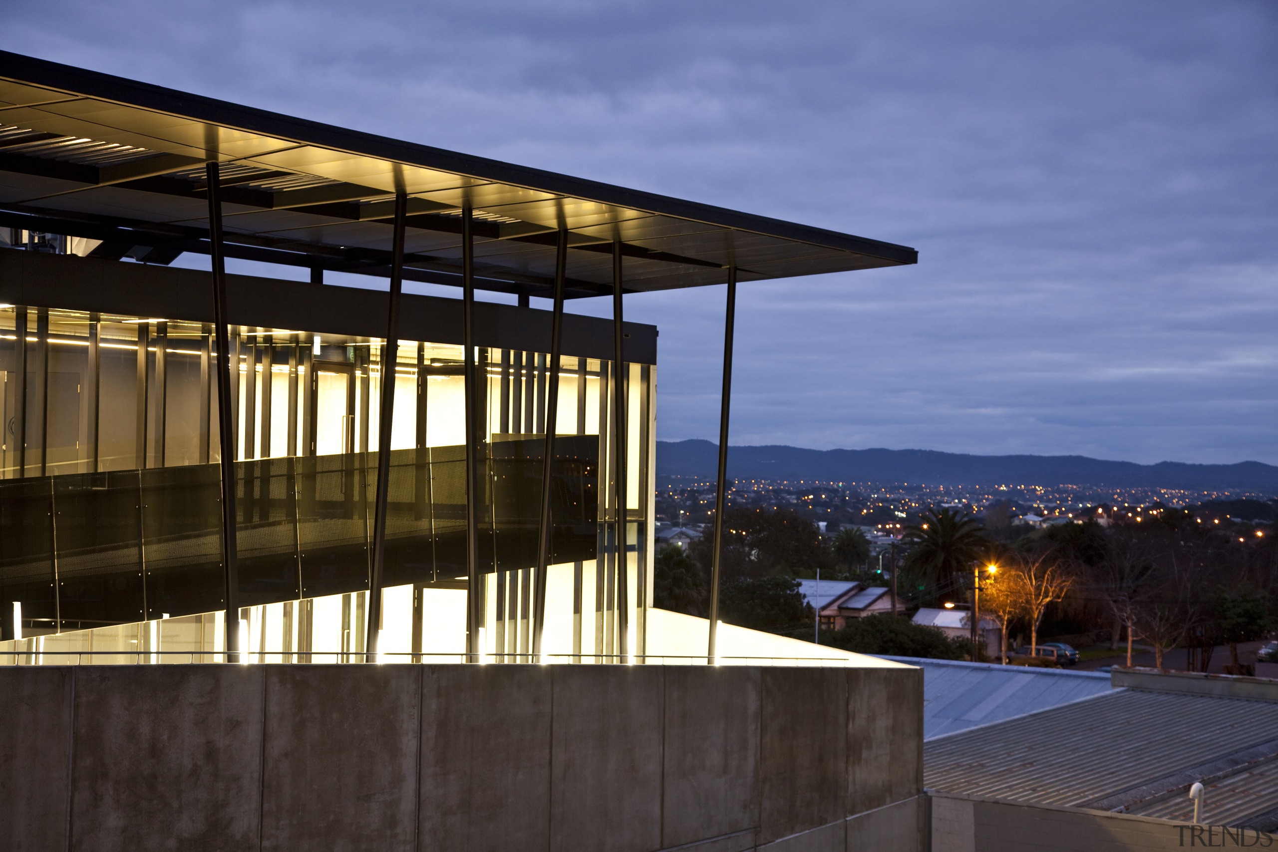 View of the Anvil Building, with angled custom architecture, building, evening, facade, home, house, real estate, reflection, residential area, roof, sky, window, black, blue