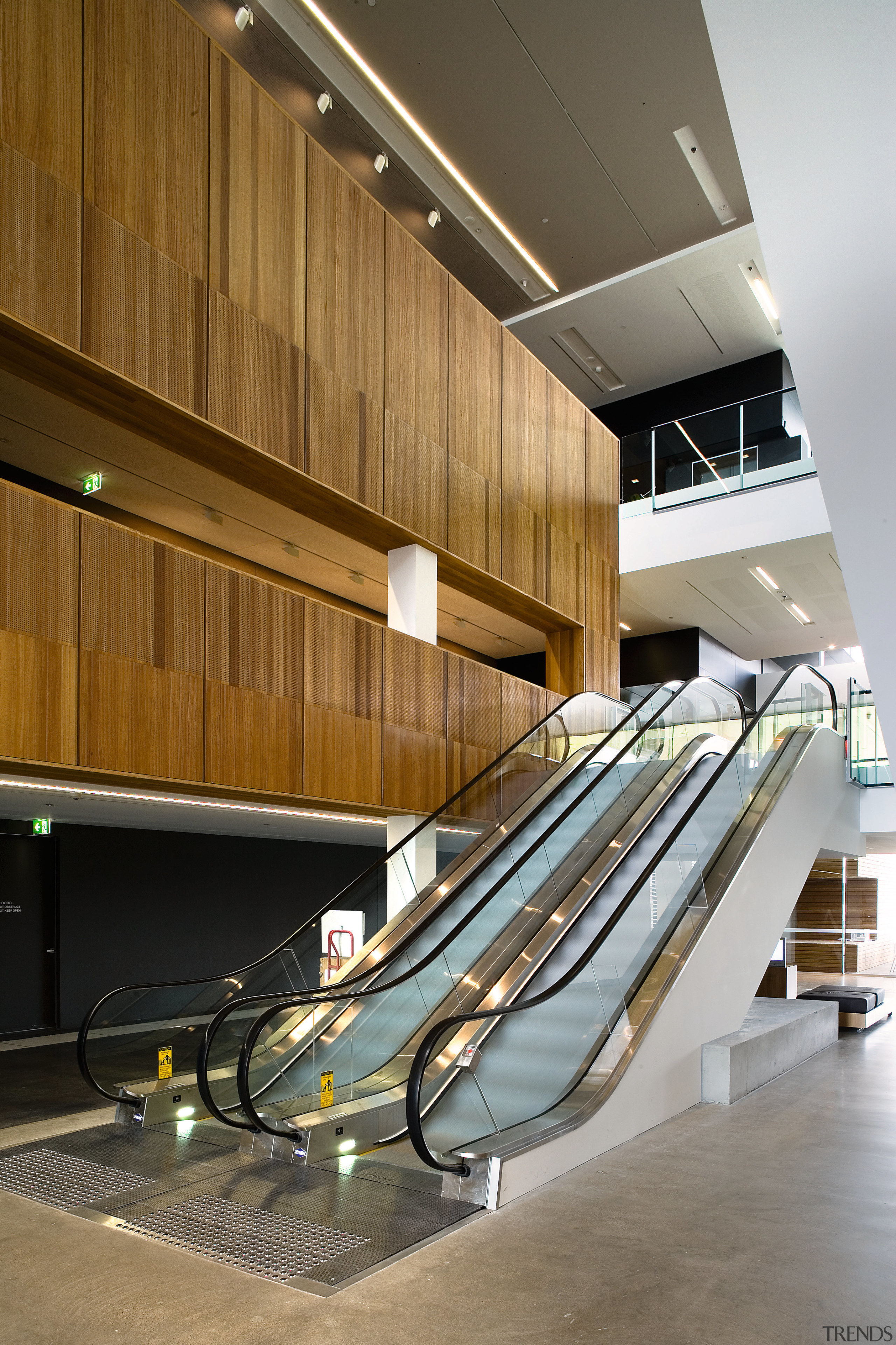 A view of some esculators from Liftronic. - architecture, daylighting, floor, handrail, interior design, stairs, wood, brown, gray