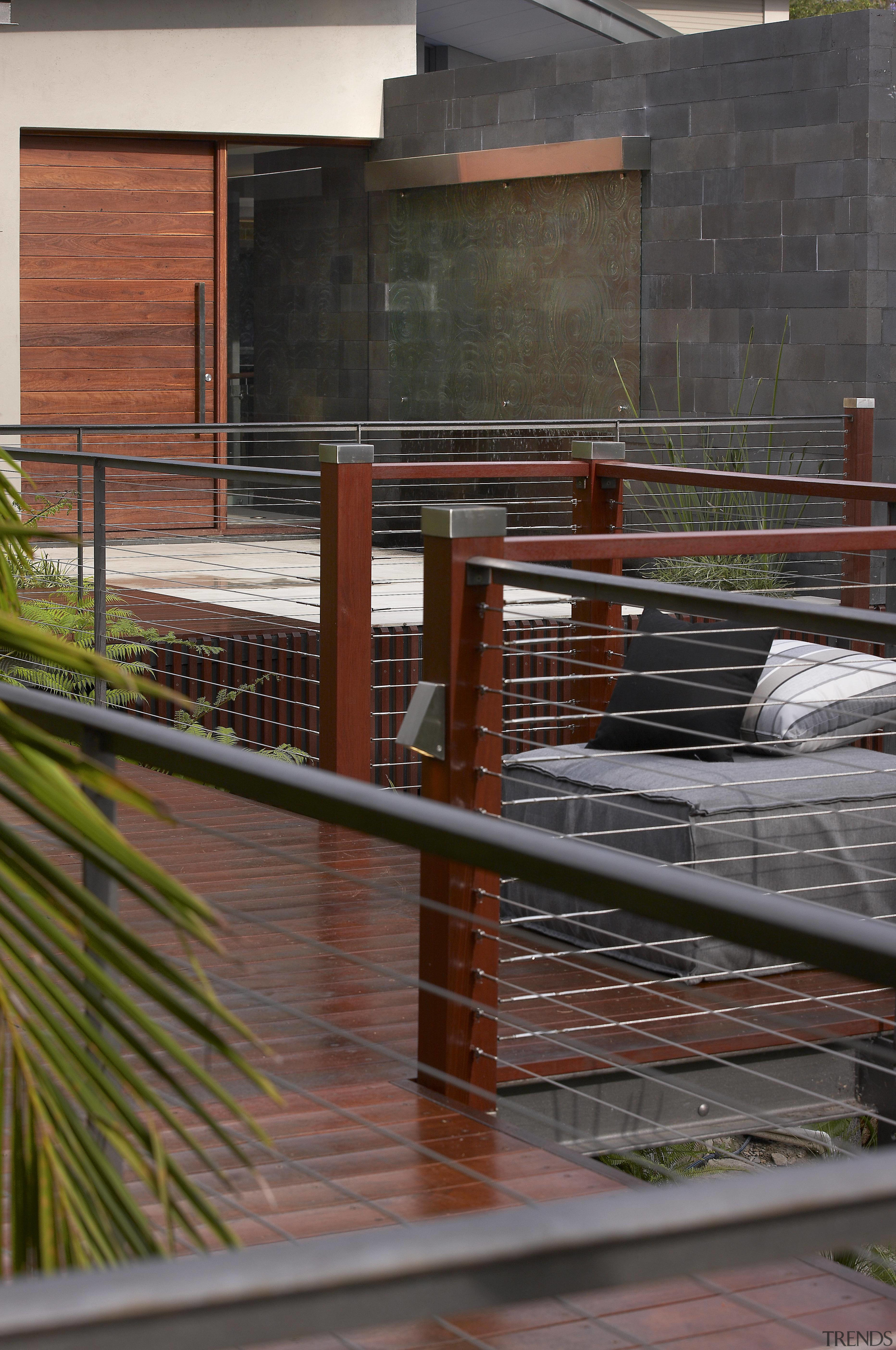 This boardwalk to a front door features a architecture, facade, wood, red, black