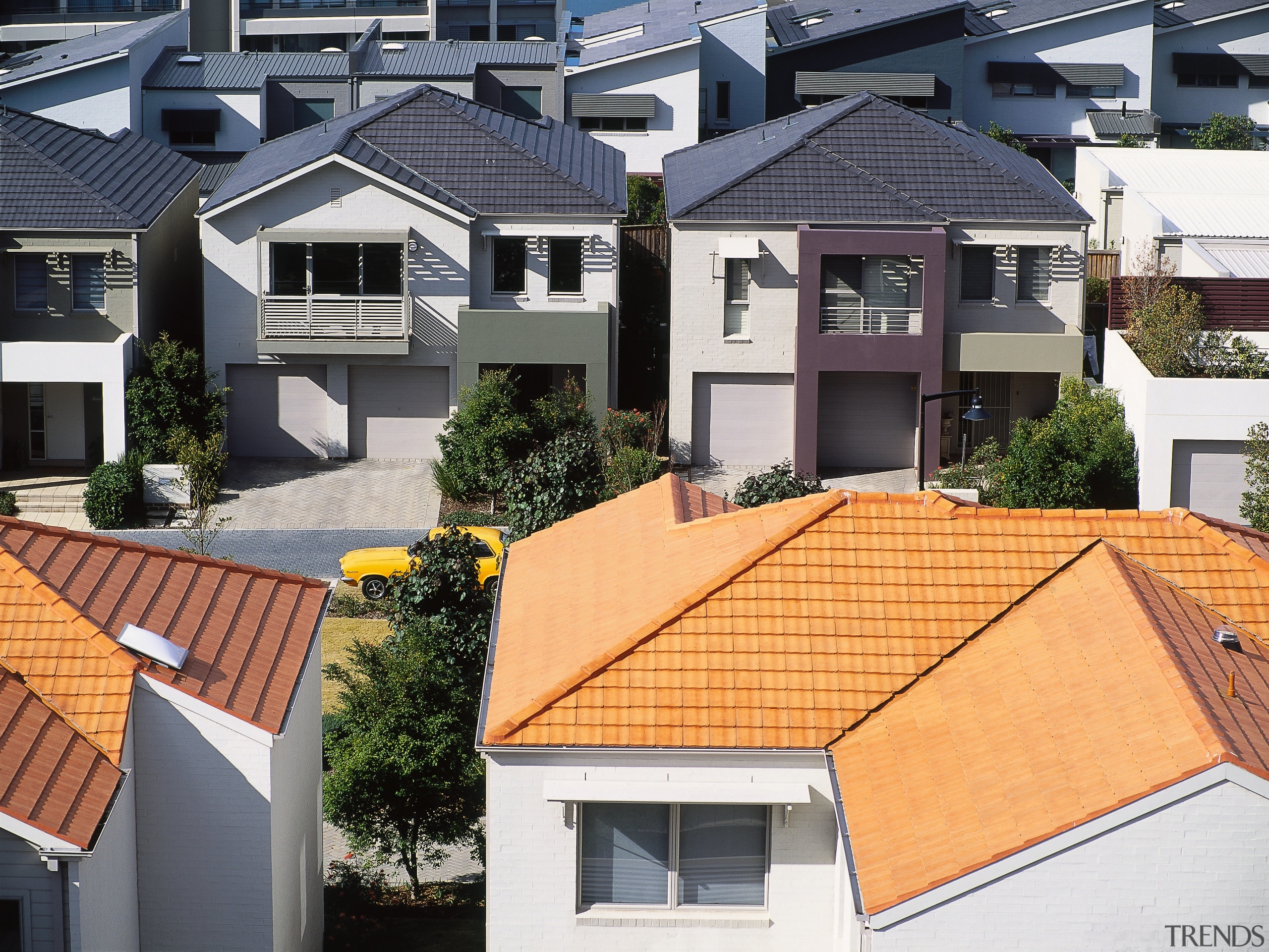 Roses of white houses in housing development, with building, elevation, estate, facade, home, house, neighbourhood, outdoor structure, property, real estate, residential area, roof, siding, suburb, window