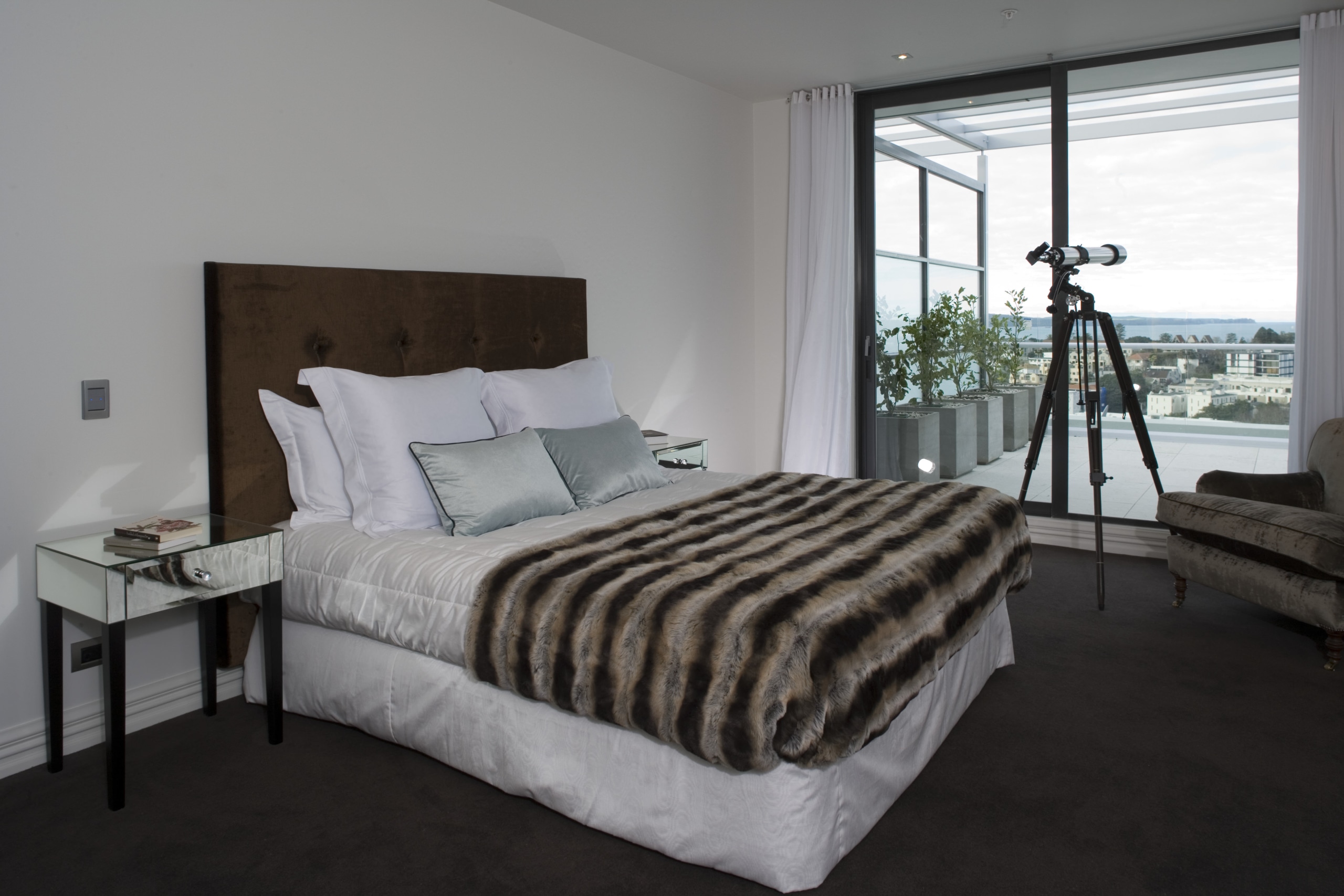 Simple, classic styling defines the apartment interiors. The bed frame, bedroom, floor, home, interior design, mattress, property, real estate, room, window, wood, gray, black