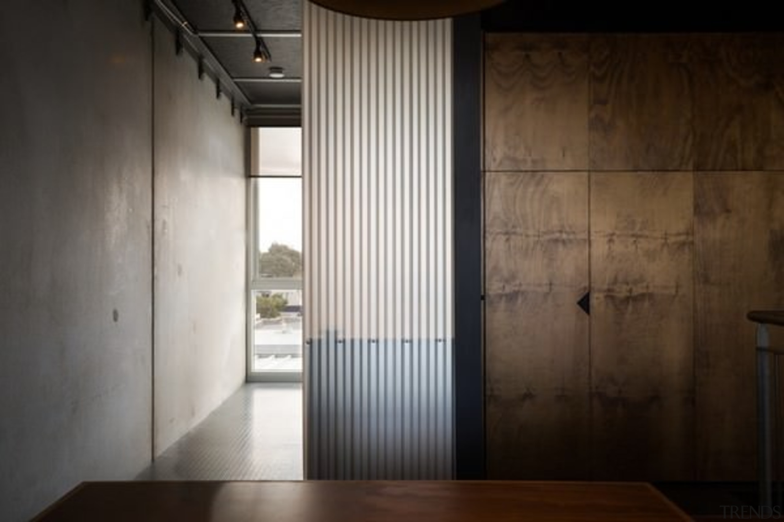 Stained plywood walls add to the industrial feeling architecture, ceiling, daylighting, door, floor, house, interior design, property, wall, window, wood, black