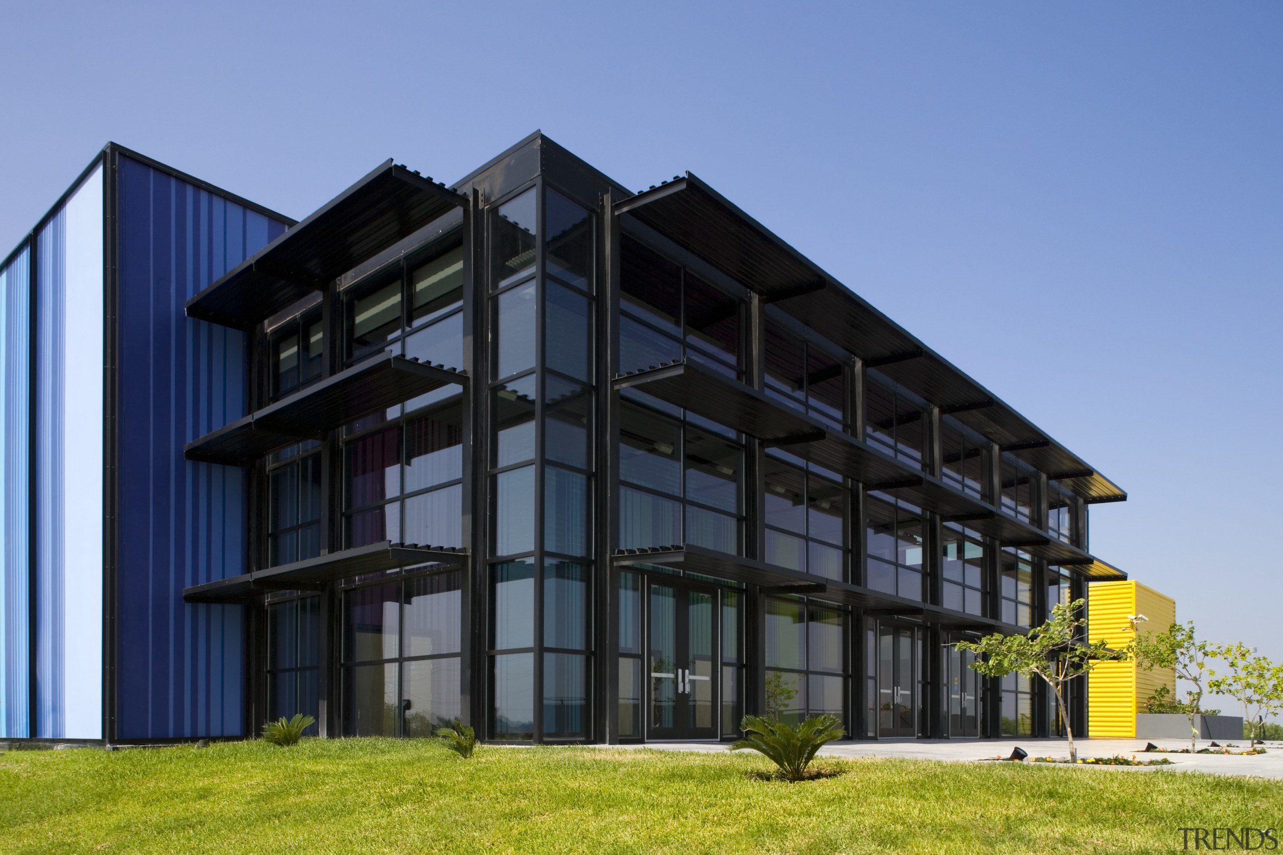 Exterior view of the Edcouch-Elsa Fine Arts Centre apartment, architecture, building, commercial building, condominium, corporate headquarters, elevation, facade, headquarters, home, house, mixed use, property, real estate, teal, black