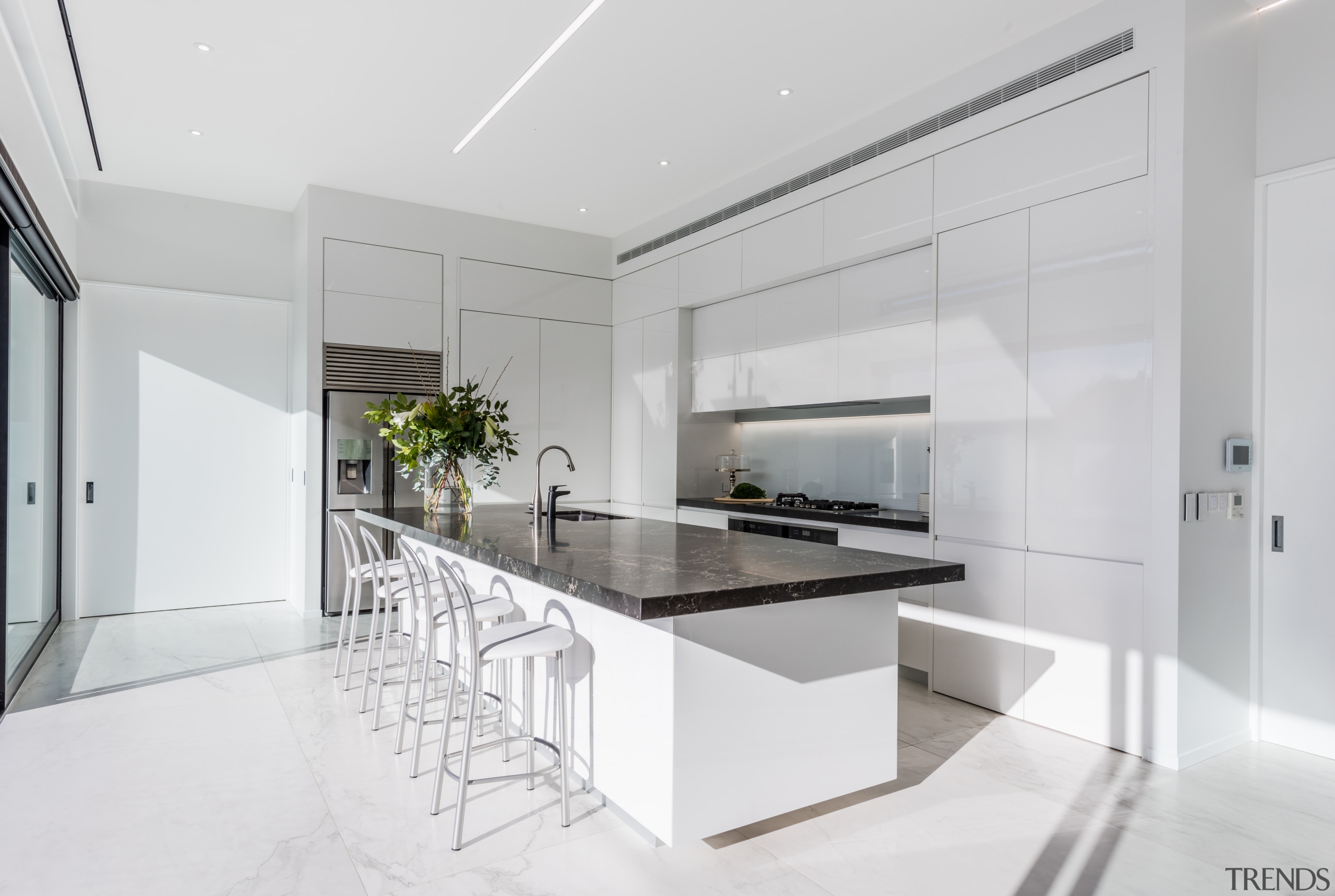 ​​​​​​​The fridge is set to the side of architecture, countertop, benchtop, interior design, kitchen, white cabinetry,  Ceasarstone, Island, Emma Morris, Eterno Design
