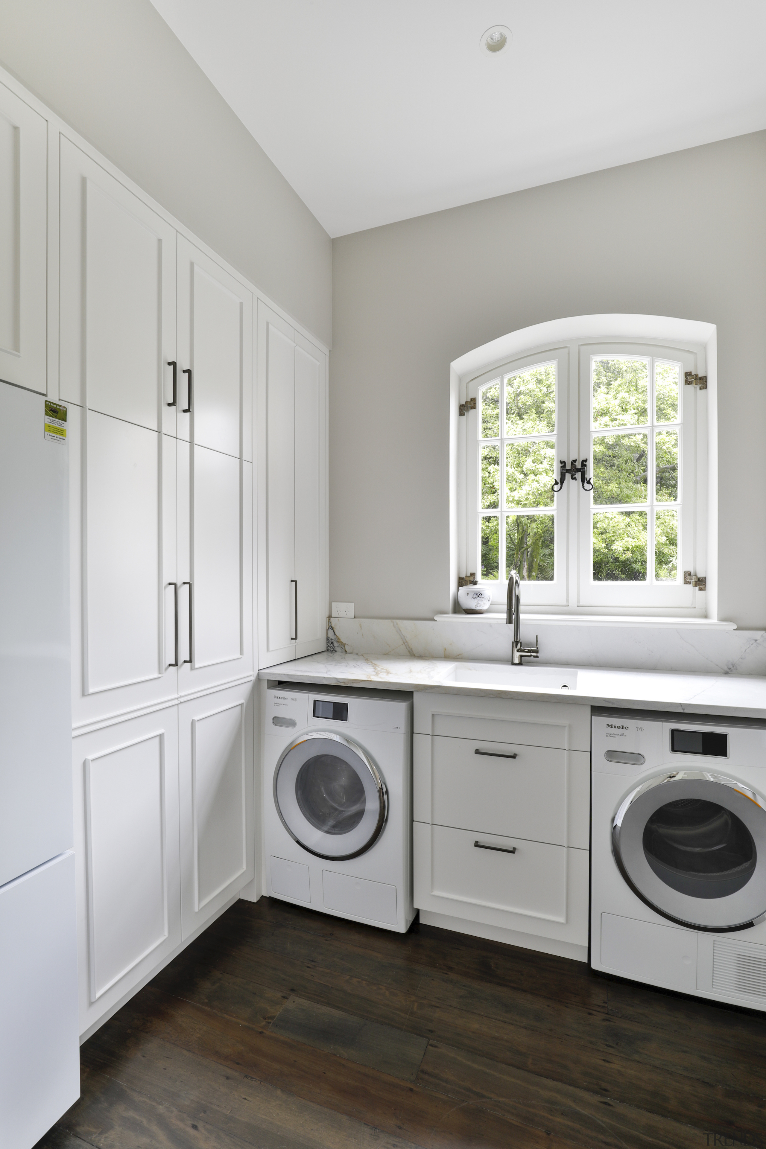 The laundry is replete with hand-crafted cabinetry solutions 