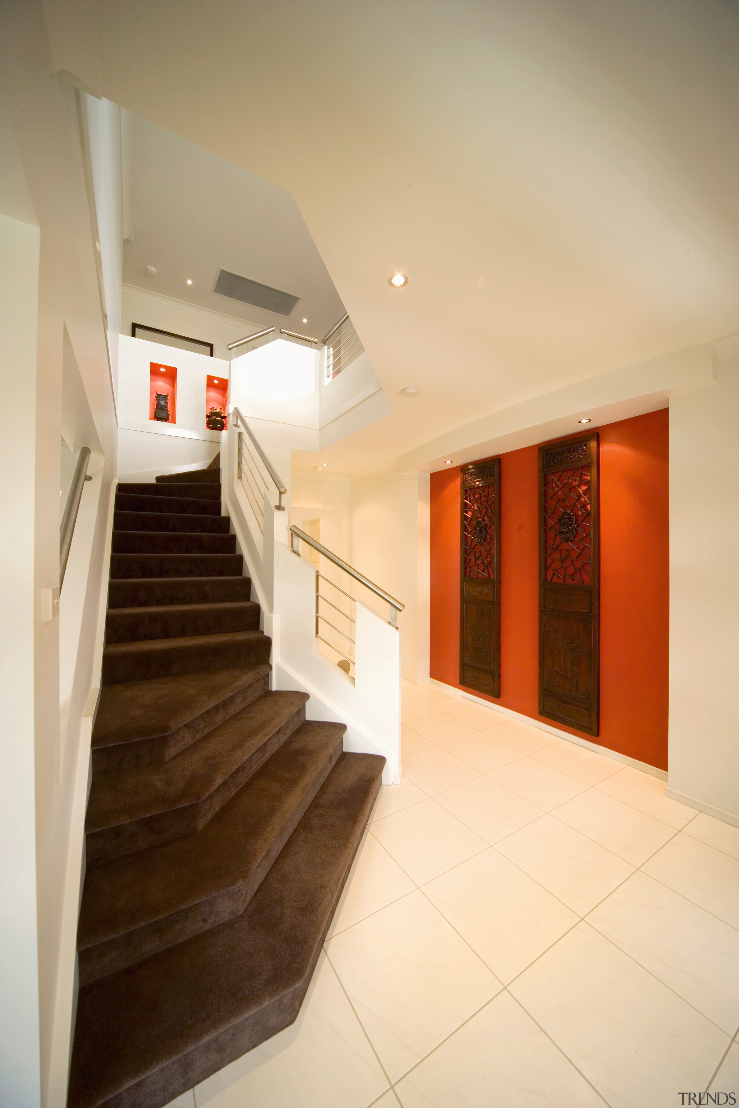 Stairwell with brown carpeted steps, cream walls and apartment, architecture, ceiling, daylighting, estate, floor, flooring, home, house, interior design, lobby, property, real estate, room, stairs, orange, brown