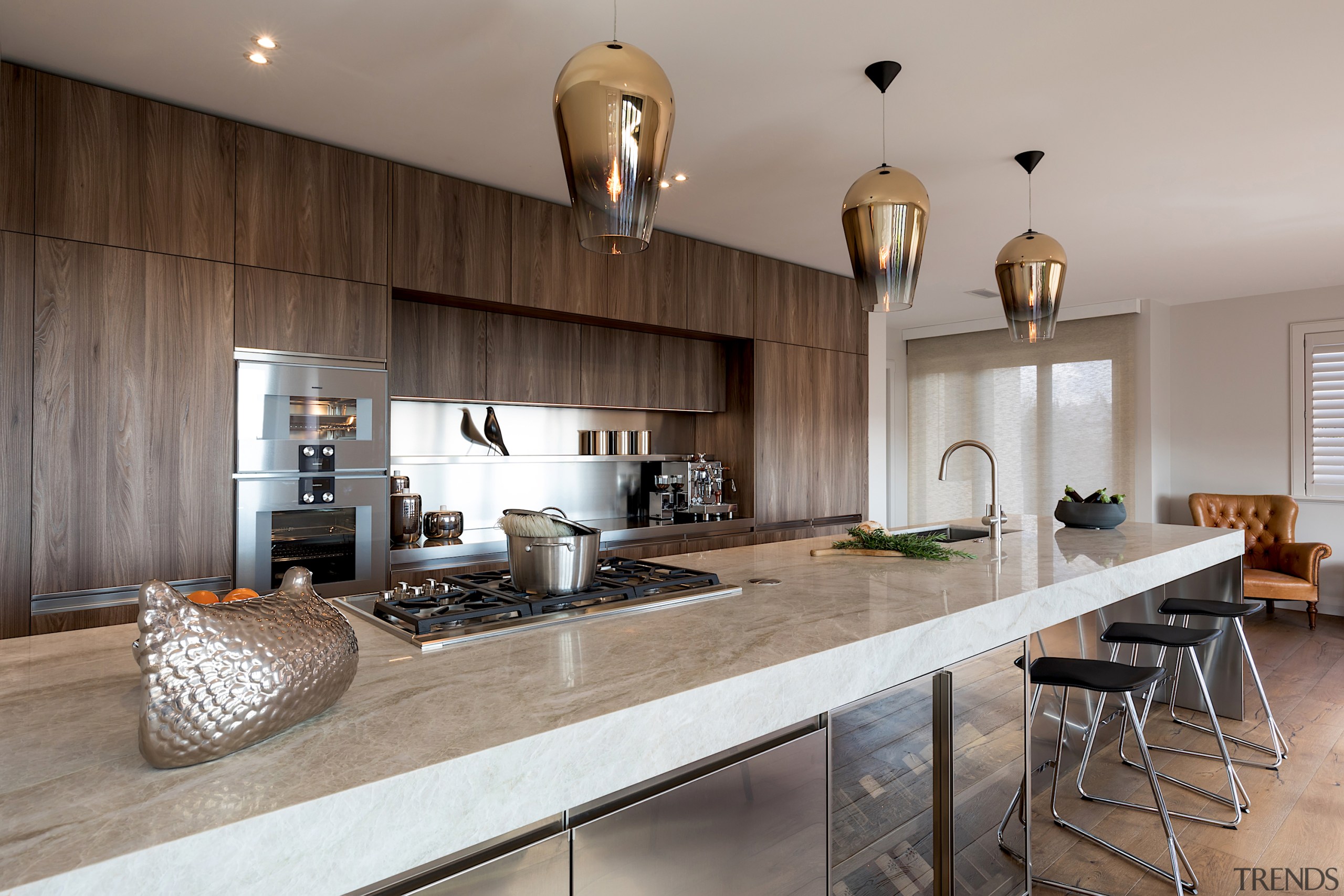 Three large pendants’ have been used to support architecture, building, cabinetry, ceiling, countertop, cuisine classique, design, floor, flooring, furniture, granite, hardwood, home, house, interior design, kitchen, loft, property, real estate, room, table, tile, wood, wood flooring, gray