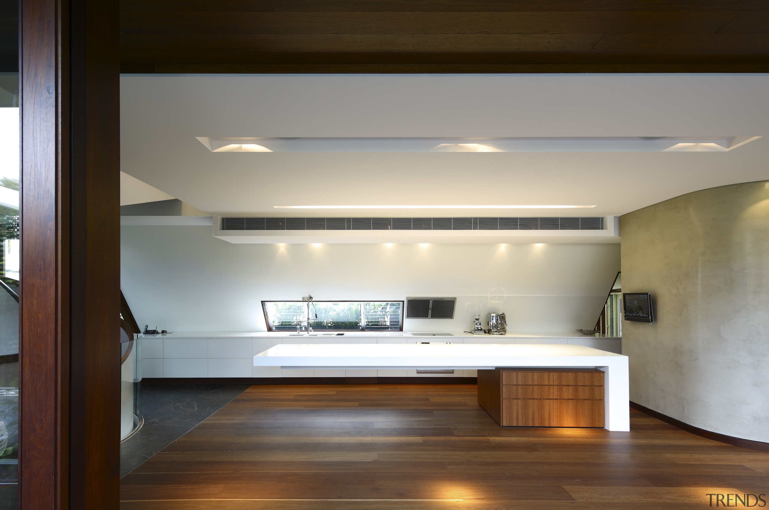 View of kitchen area featuring hardwood flooring, island architecture, ceiling, daylighting, floor, flooring, hardwood, house, interior design, lighting, loft, room, wood, brown, gray