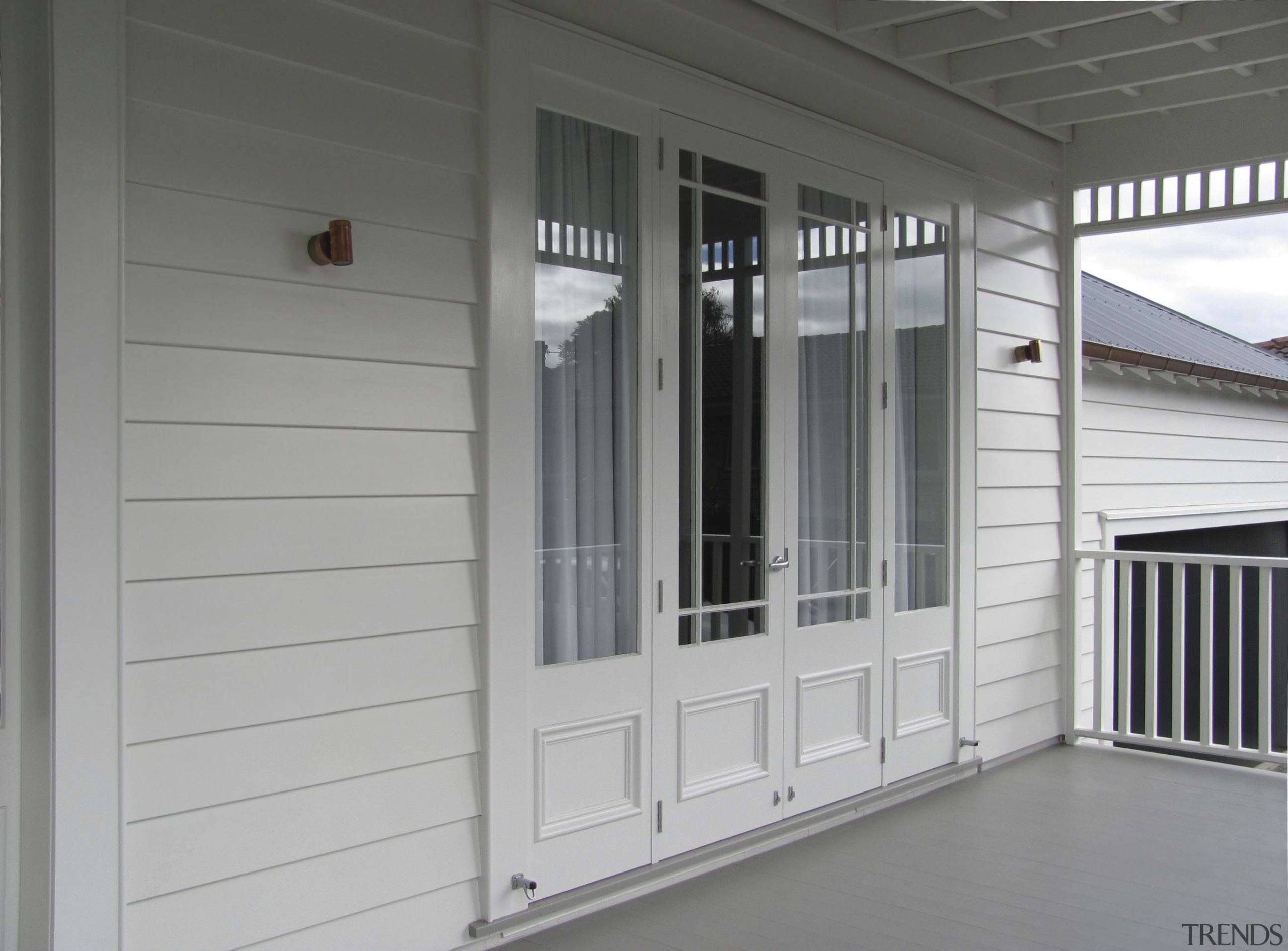 View of a renovated two-storey villa which features door, siding, structure, window, gray