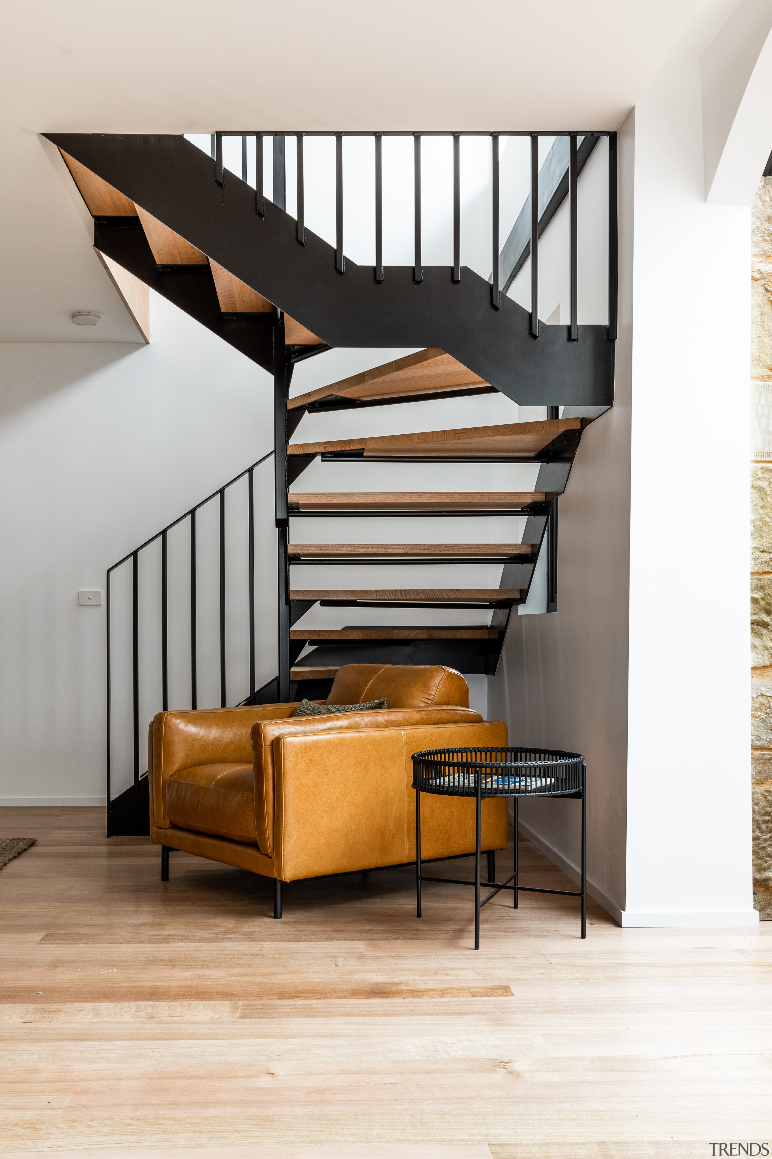 ​​​​​​​A black steel staircase with timber treads is white