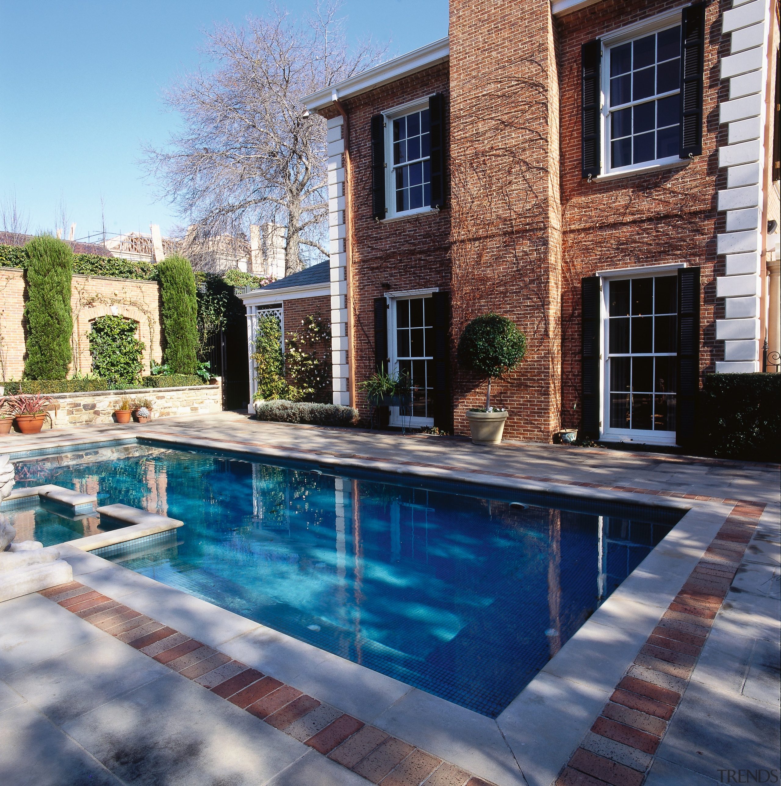 View of the pool and patio area, brick backyard, estate, home, house, outdoor structure, patio, property, real estate, reflection, swimming pool, water, window