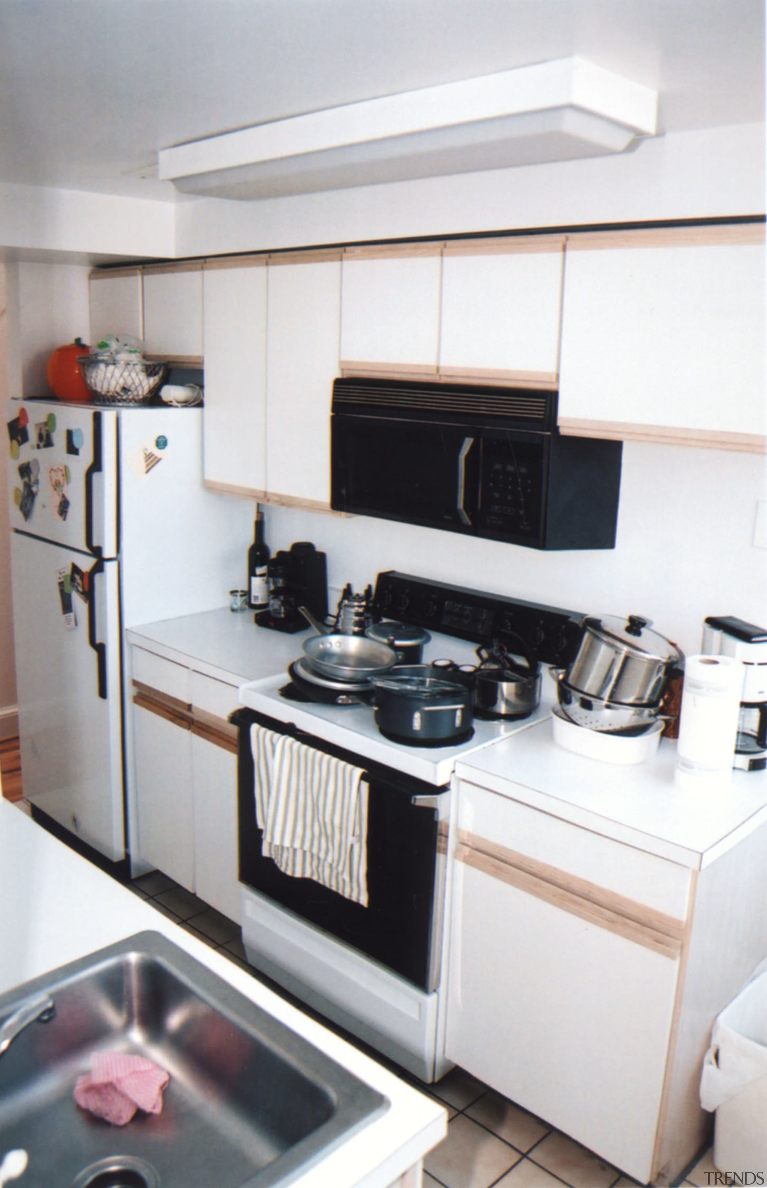 view of kitchen and living area before renovations countertop, home appliance, kitchen, kitchen stove, room, yacht, white