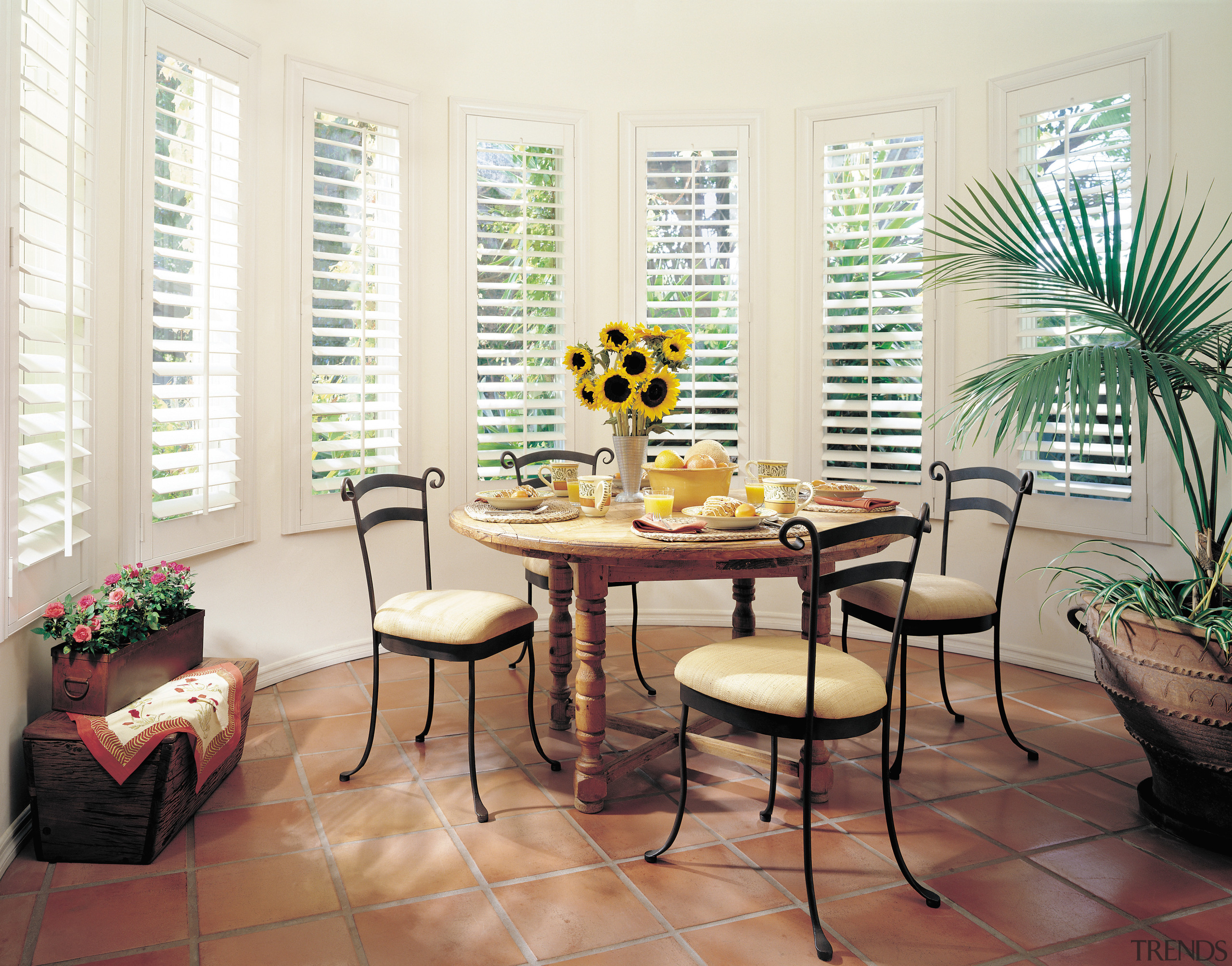 A view of some wooden blinds in the chair, dining room, furniture, home, interior design, living room, room, table, window, window covering, window treatment, white