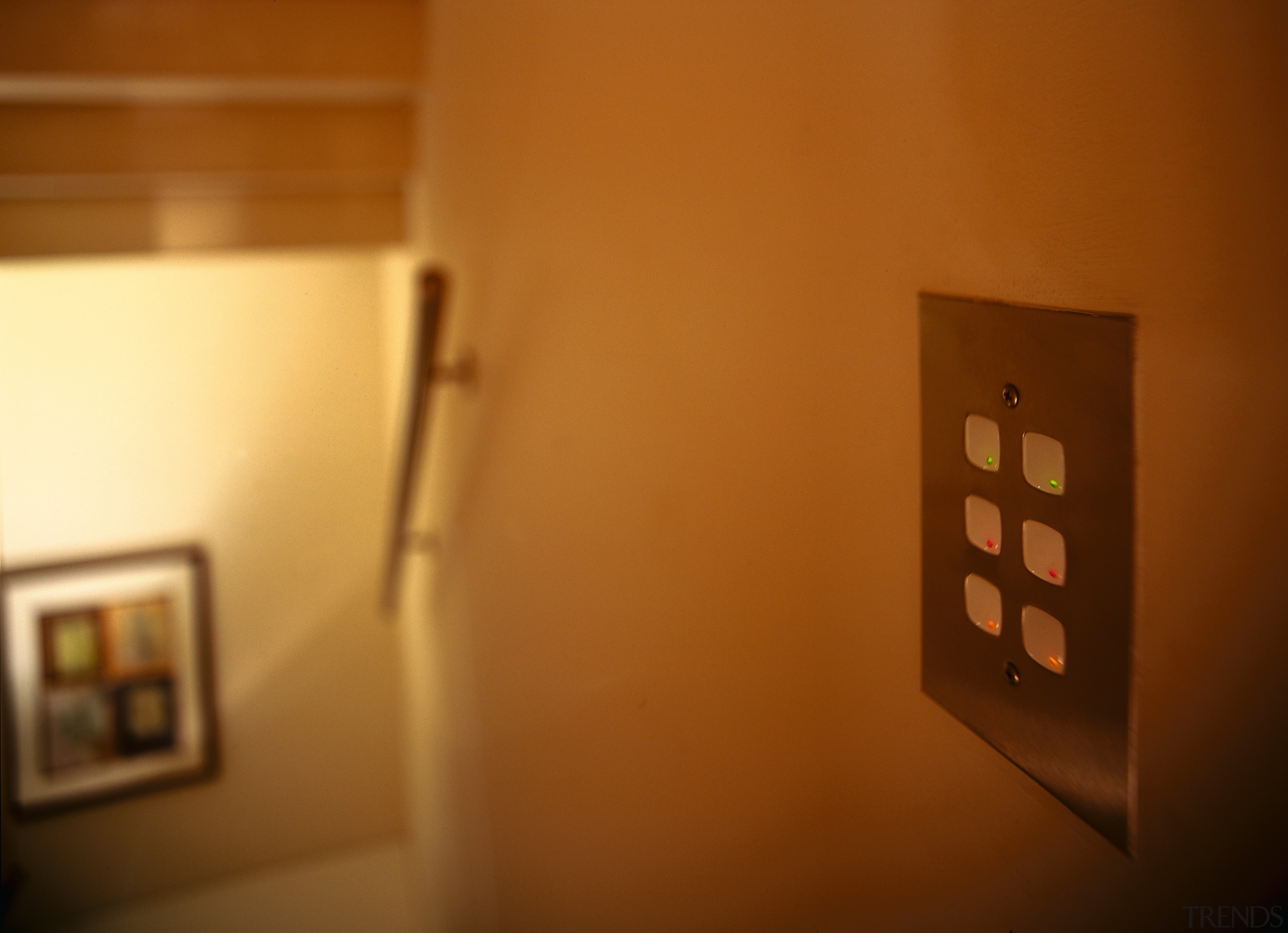 A view of the keypad used to control home, house, light, light fixture, lighting, room, tourist attraction, wood, brown