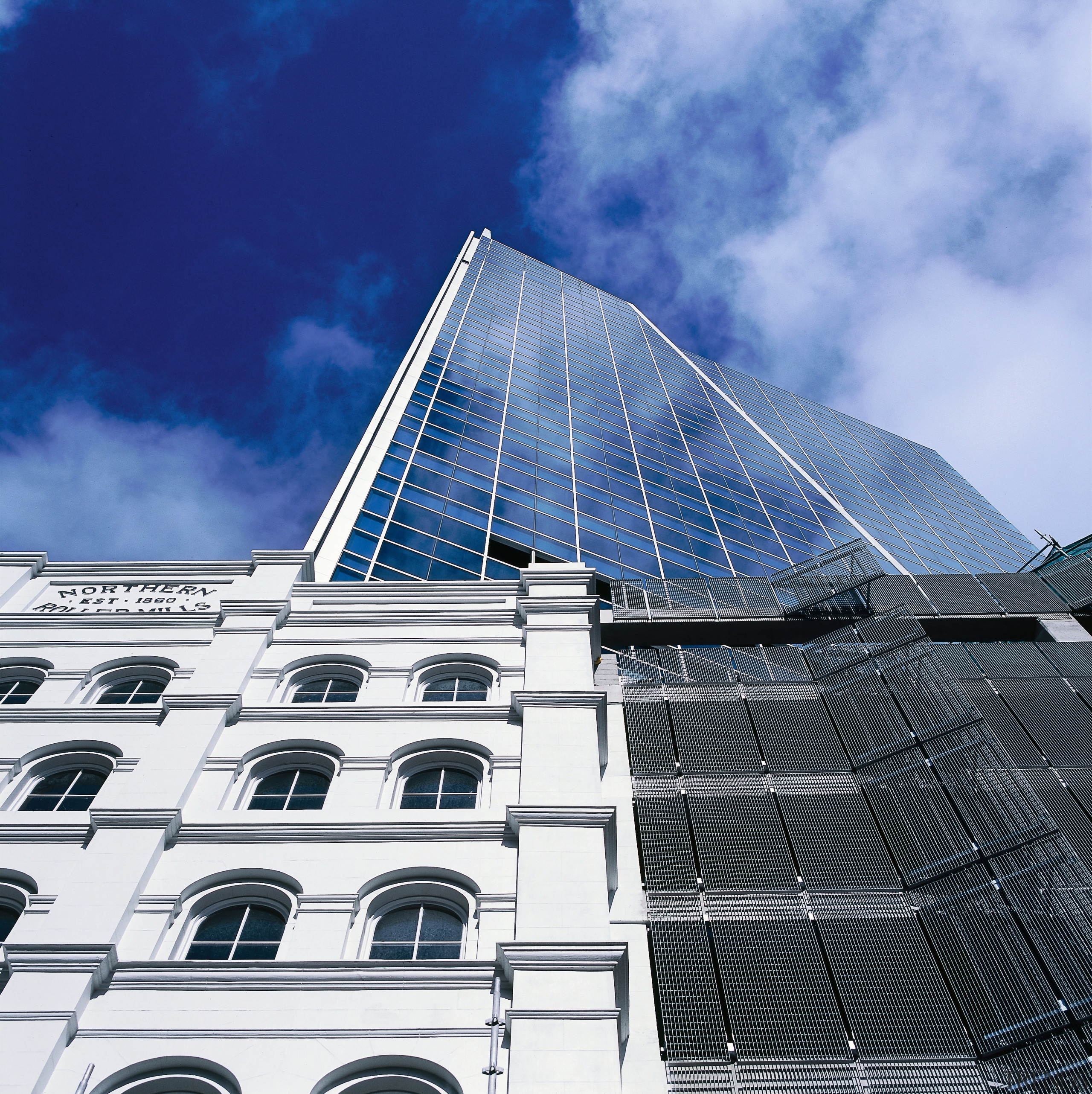 view looking up of the roller mills facade architecture, building, commercial building, corporate headquarters, daylighting, daytime, facade, headquarters, landmark, metropolis, metropolitan area, sky, skyscraper, tower block, white