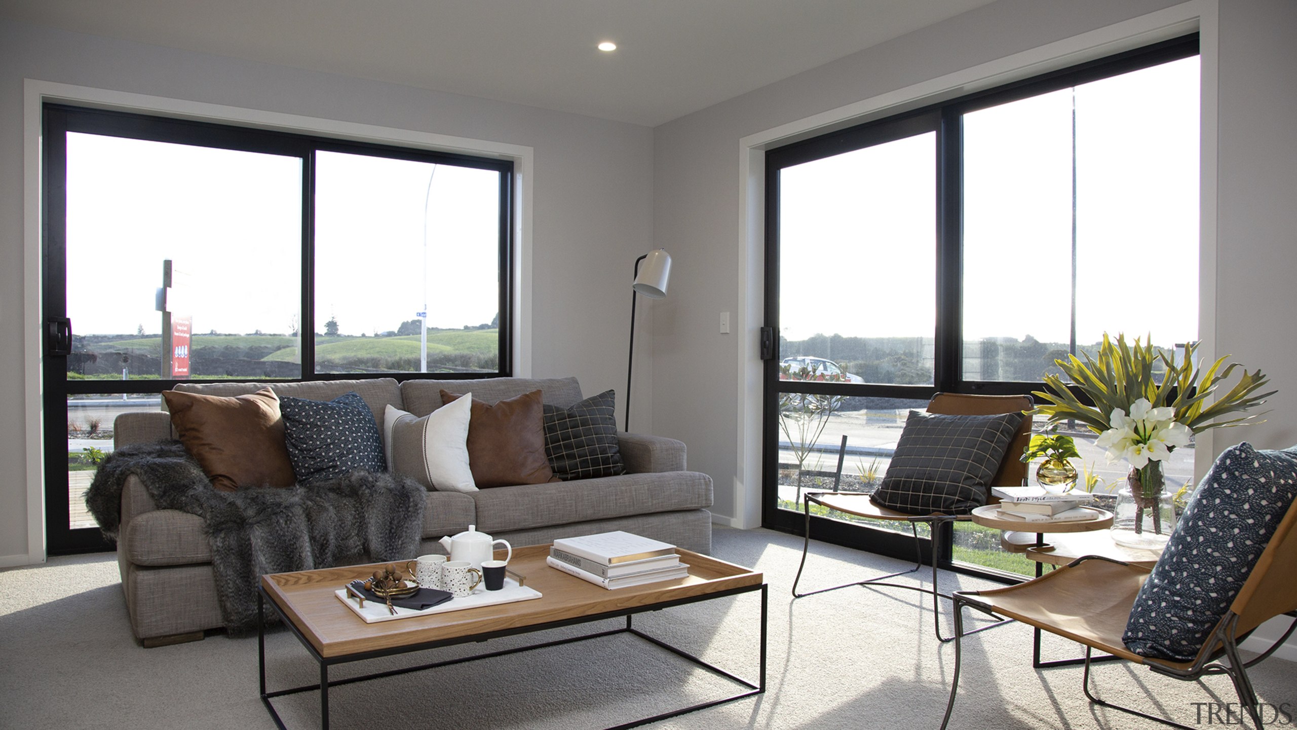 Two picture windows/sliders and a raked ceiling give 