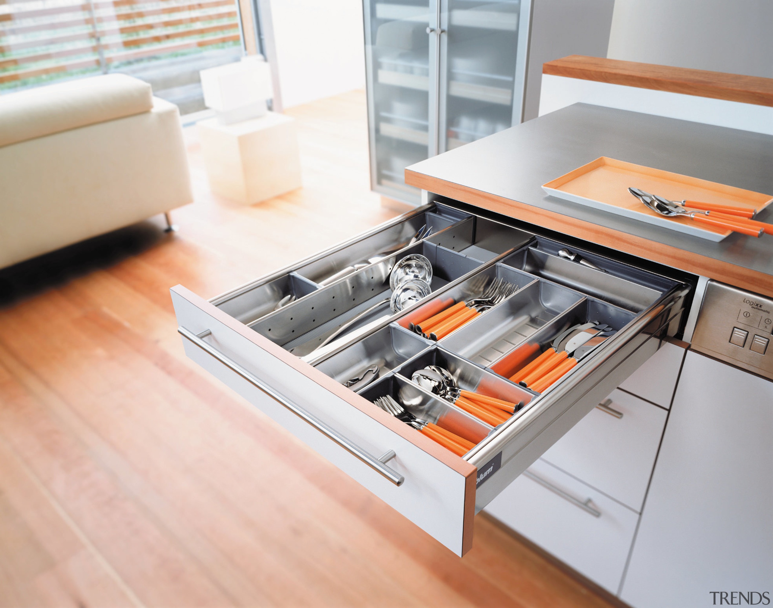 A view of a kitchen area, wooden flooring, countertop, drawer, floor, furniture, kitchen, product design, table, white, gray