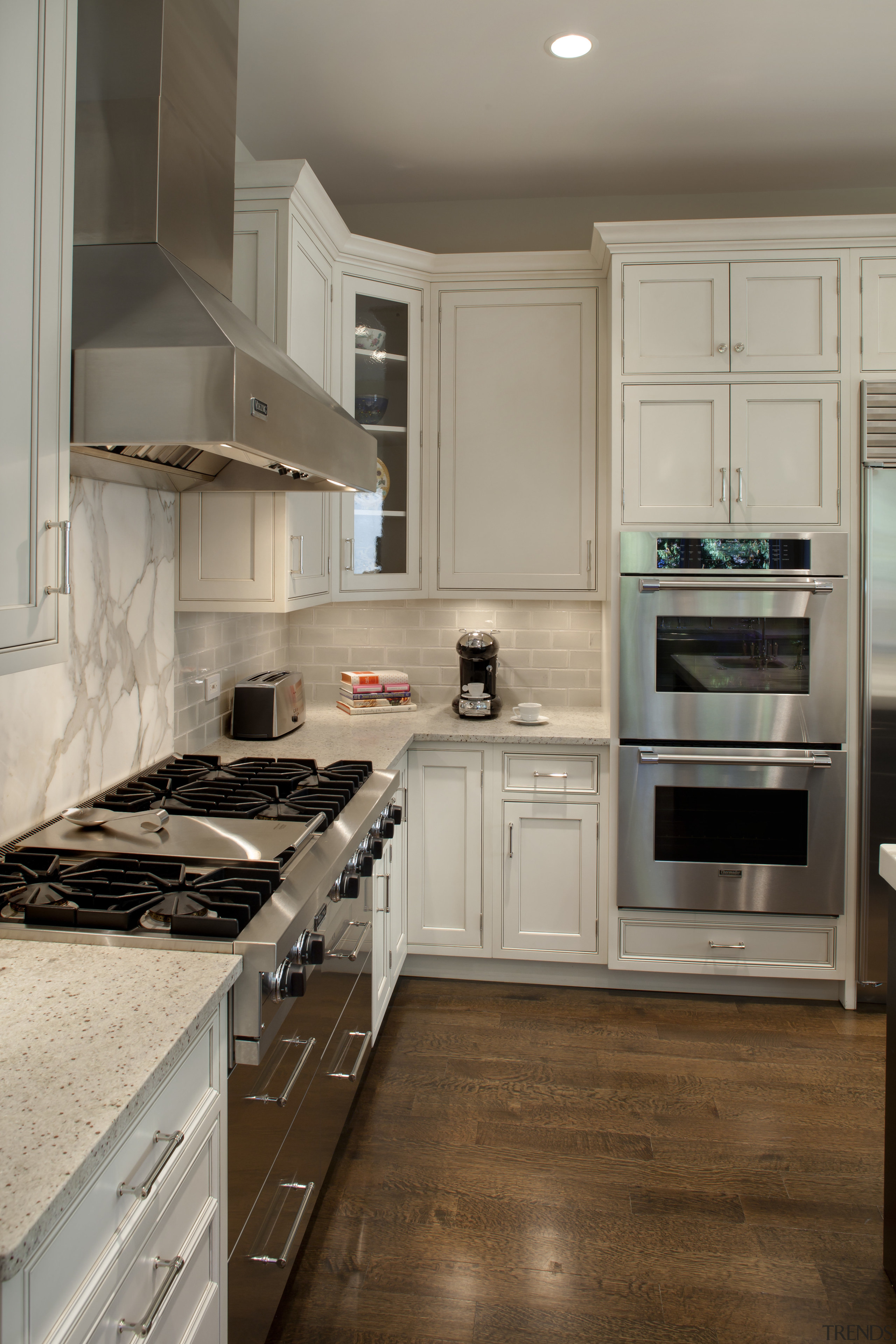 View of kitchen with wooden flooring, stainless drawers cabinetry, countertop, cuisine classique, floor, flooring, hardwood, home appliance, interior design, kitchen, kitchen appliance, room, gray, brown