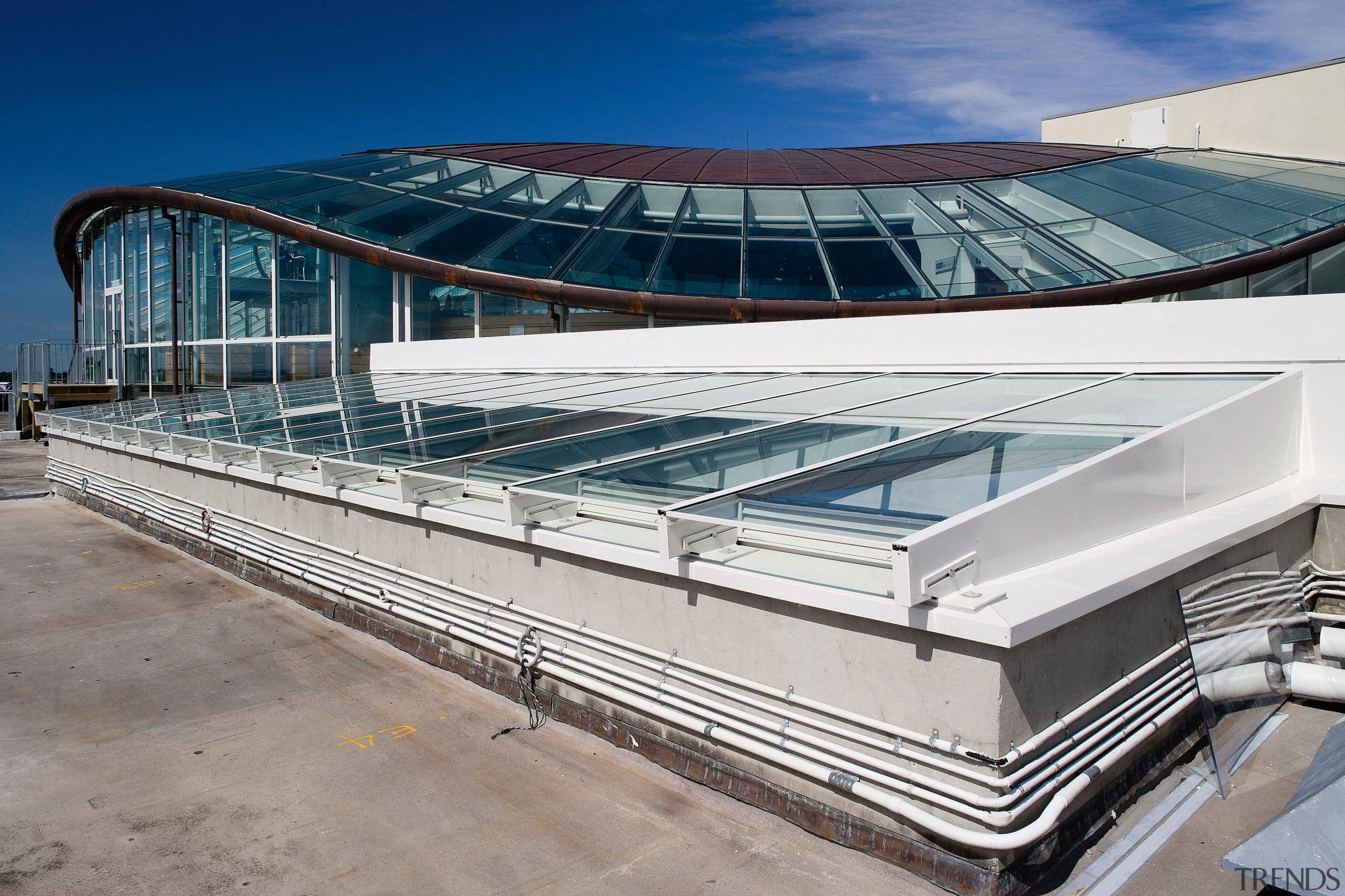 A vie wof some glass windows from Woods architecture, building, corporate headquarters, daylighting, roof, structure, gray