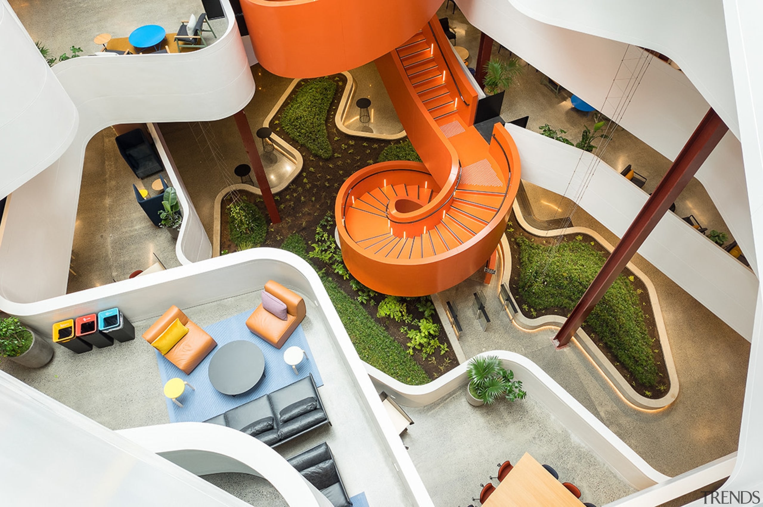 The vibrant, spiral staircase in the atrium of white