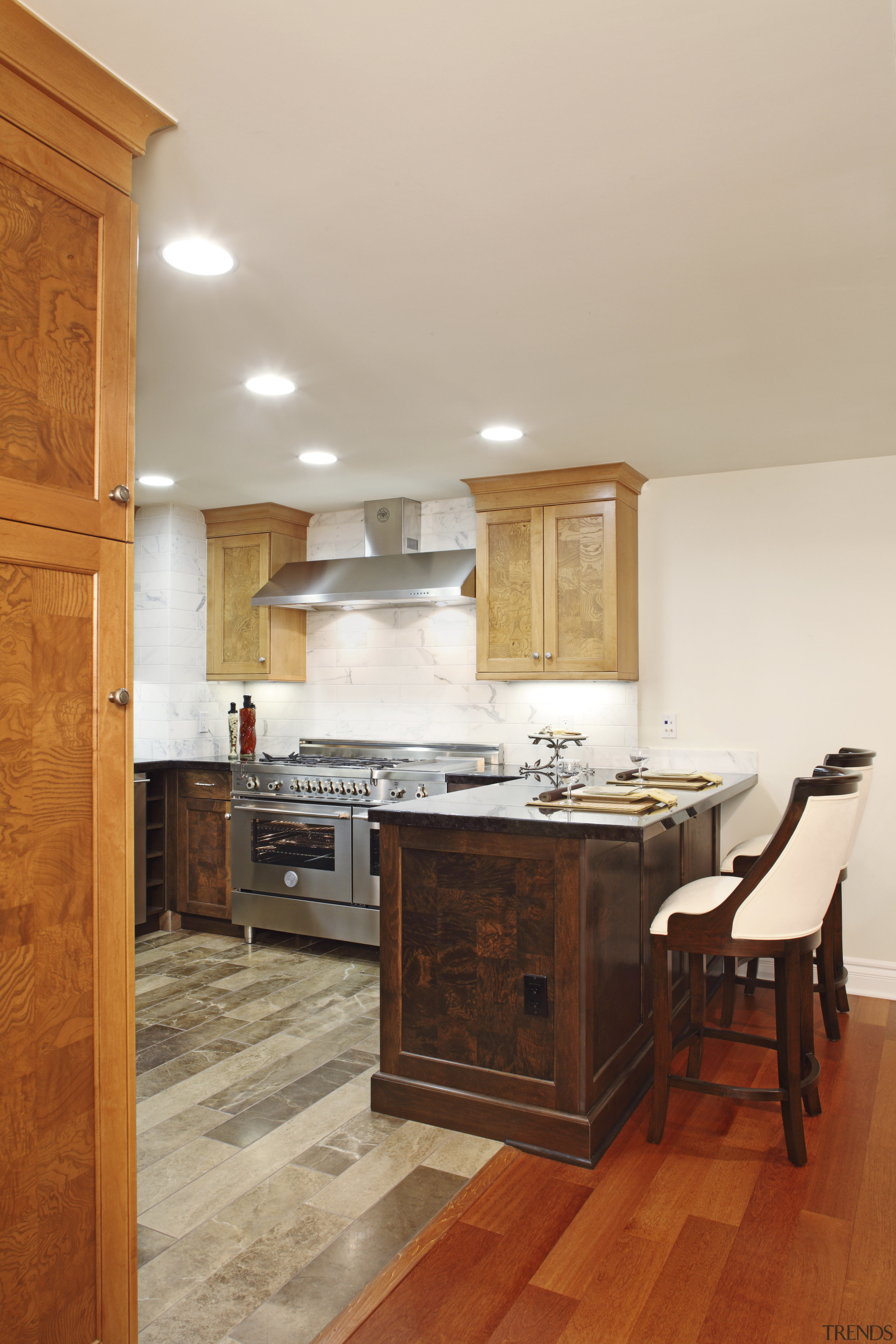 View of a contemporary kitchen which features a cabinetry, ceiling, countertop, cuisine classique, floor, flooring, hardwood, home, interior design, kitchen, laminate flooring, real estate, room, tile, wall, wood, wood flooring, wood stain, gray, brown